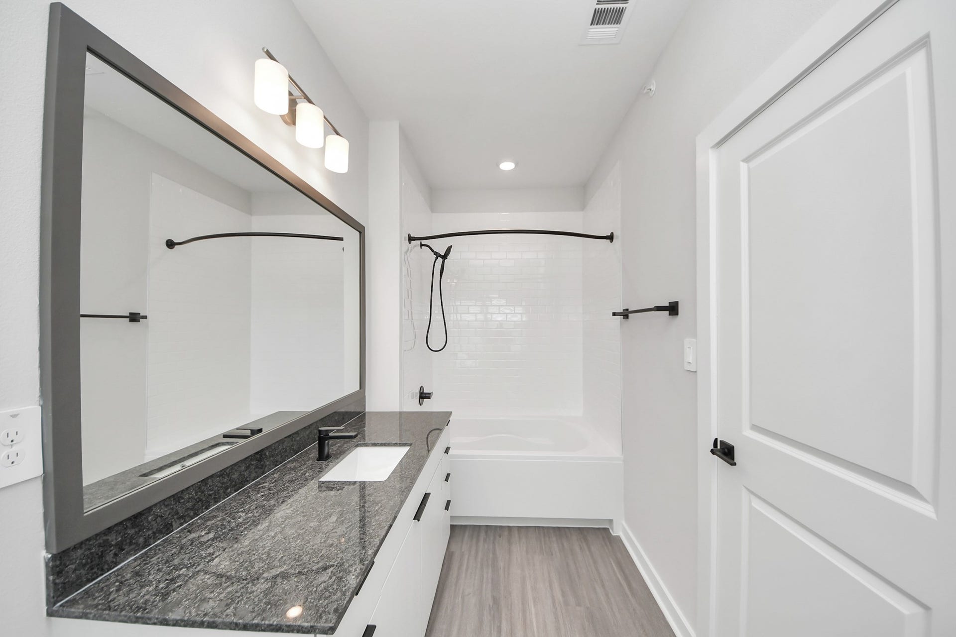 7711 Longmire Road, #97, Conroe, TX 77304 Primary Suite offers walk-closet,bath w/granite vanity&lux tub/shower.