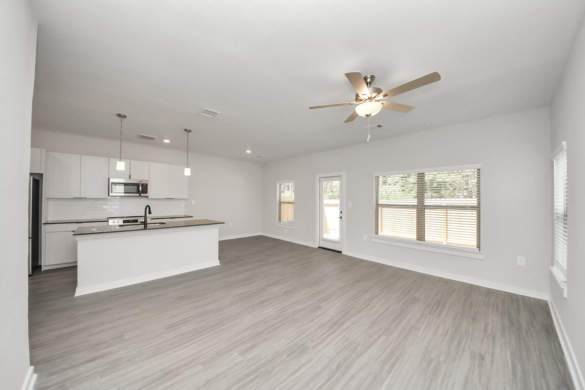7711 Longmire Road, #97, Conroe, TX 77304 Boasting luxury finishes-stylish Island kitchen,granite counters,subway tile backsplash,ample custom cabinet space,stainless appliances,refrigerator,full size washer&dryer included,wood-like floors throughout,open concept floor plan.