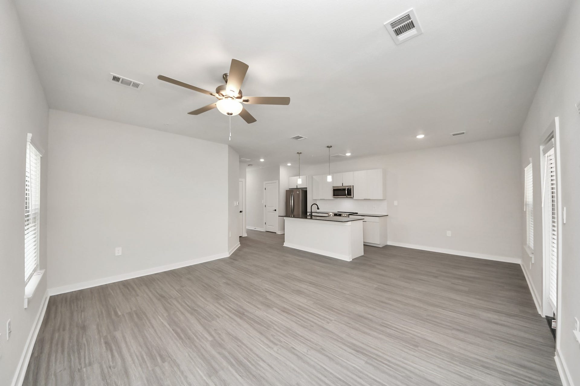 7711 Longmire Road, #97, Conroe, TX 77304 Boasting luxury finishes-stylish Island kitchen,granite counters,subway tile backsplash,ample custom cabinet space,stainless appliances,refrigerator,full size washer&dryer included,wood-like floors throughout,open concept floor plan.