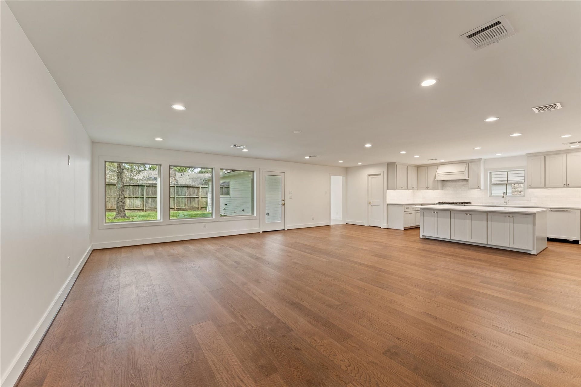 Open and spacious living space into the kitchen with custom cabinetry