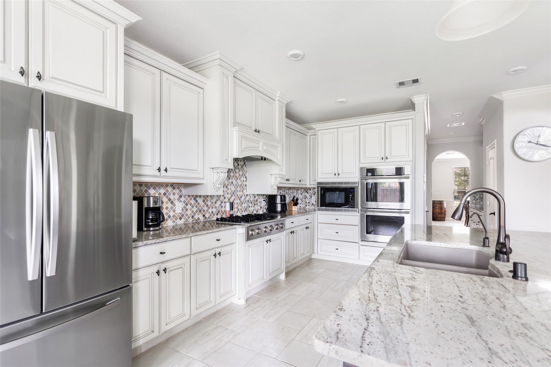 18931 Wild Thornberry Drive, Tomball, TX 77377 Maple cabinetry, granite countertops, under-cabinet lighting, and stainless steel appliances. 6-burner gas cooktop and double ovens