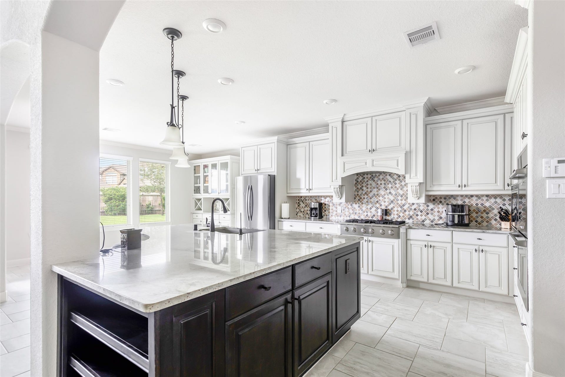 18931 Wild Thornberry Drive, Tomball, TX 77377 Beautiful two-tone maple cabinetry. Recessed & pendant lighting