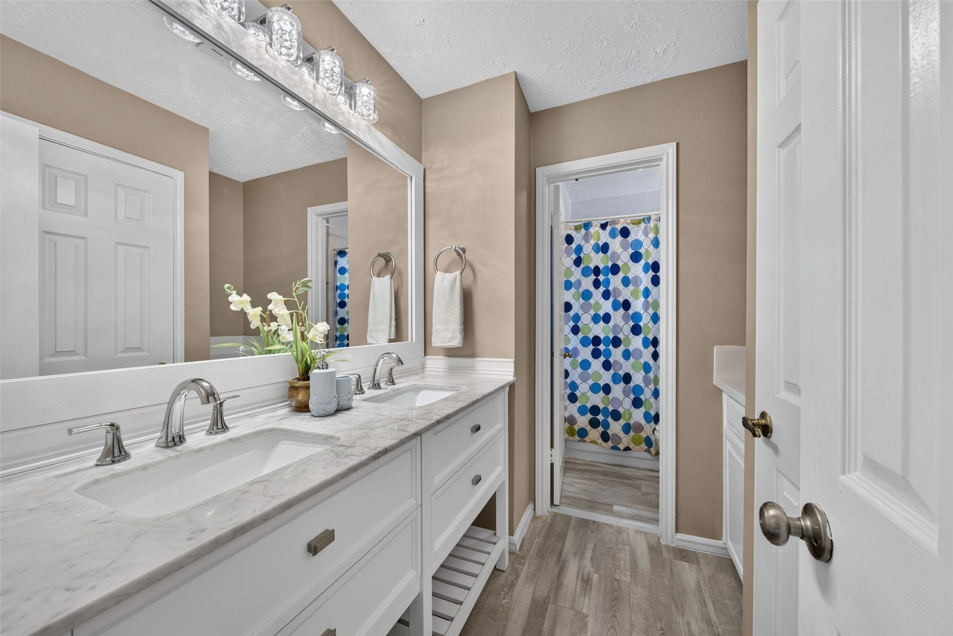 3507 Santa Rosa Lane, Sugar Land, TX 77478 A full upstairs bathroom featuring a spacious double vanity with clean white cabinetry, generous counter space, and stylish updated finishes to easily accommodate family members and guests.
