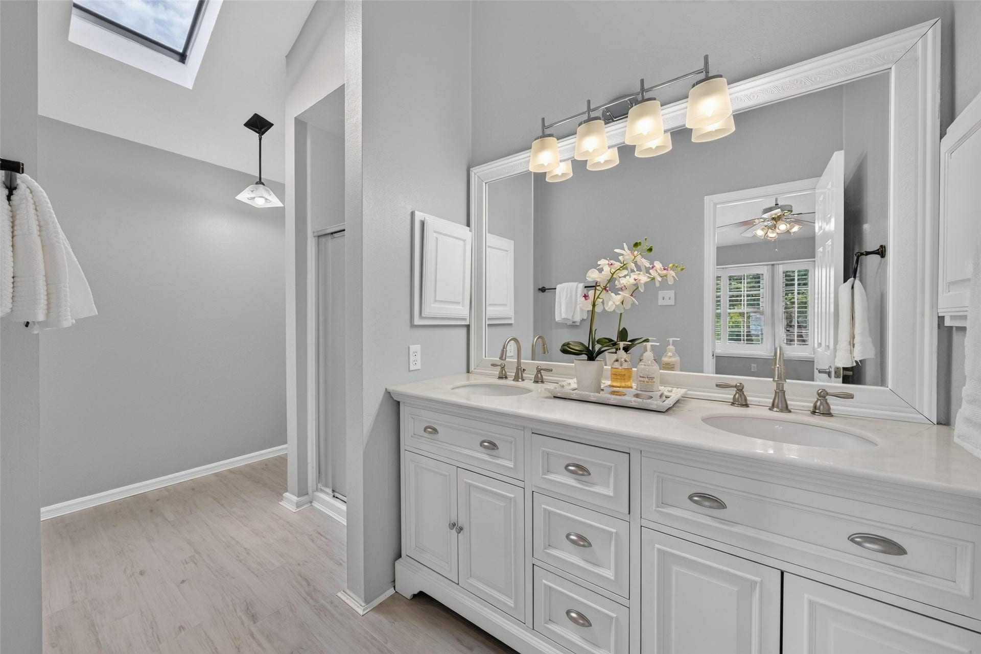 3507 Santa Rosa Lane, Sugar Land, TX 77478 A bright and elegant primary ensuite bath featuring a double vanity with crisp white cabinetry, generous counter space, and updated fixtures designed for an effortless morning routine.