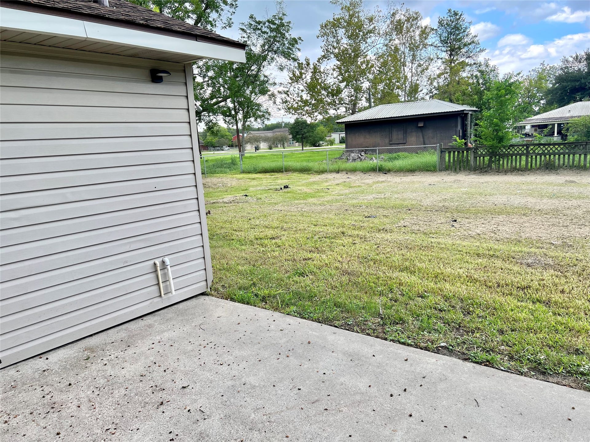 14414 2nd Street Street, Santa Fe, TX 77517 Great back patio area for BBQ and another separated fenced area in the back of the home.