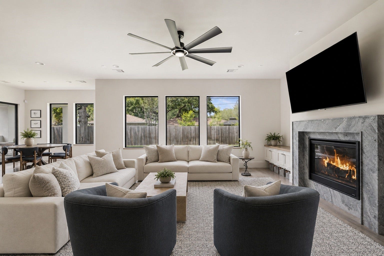 4638 Merwin Street, Houston, TX 77027 The spacious living room is anchored by a fireplace and framed by expansive windows overlooking the backyard.