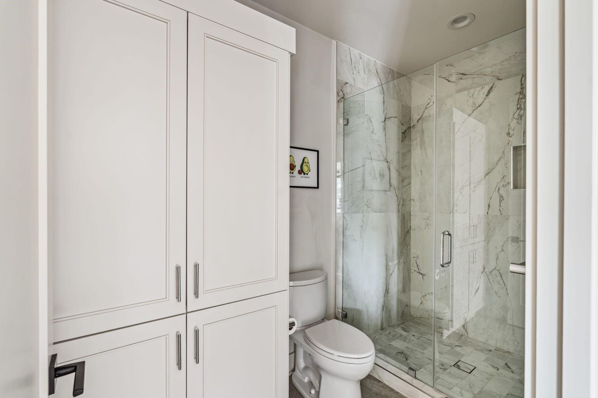 4638 Merwin Street, Houston, TX 77027 Beautiful tilework highlights the glass-enclosed walk-in shower.