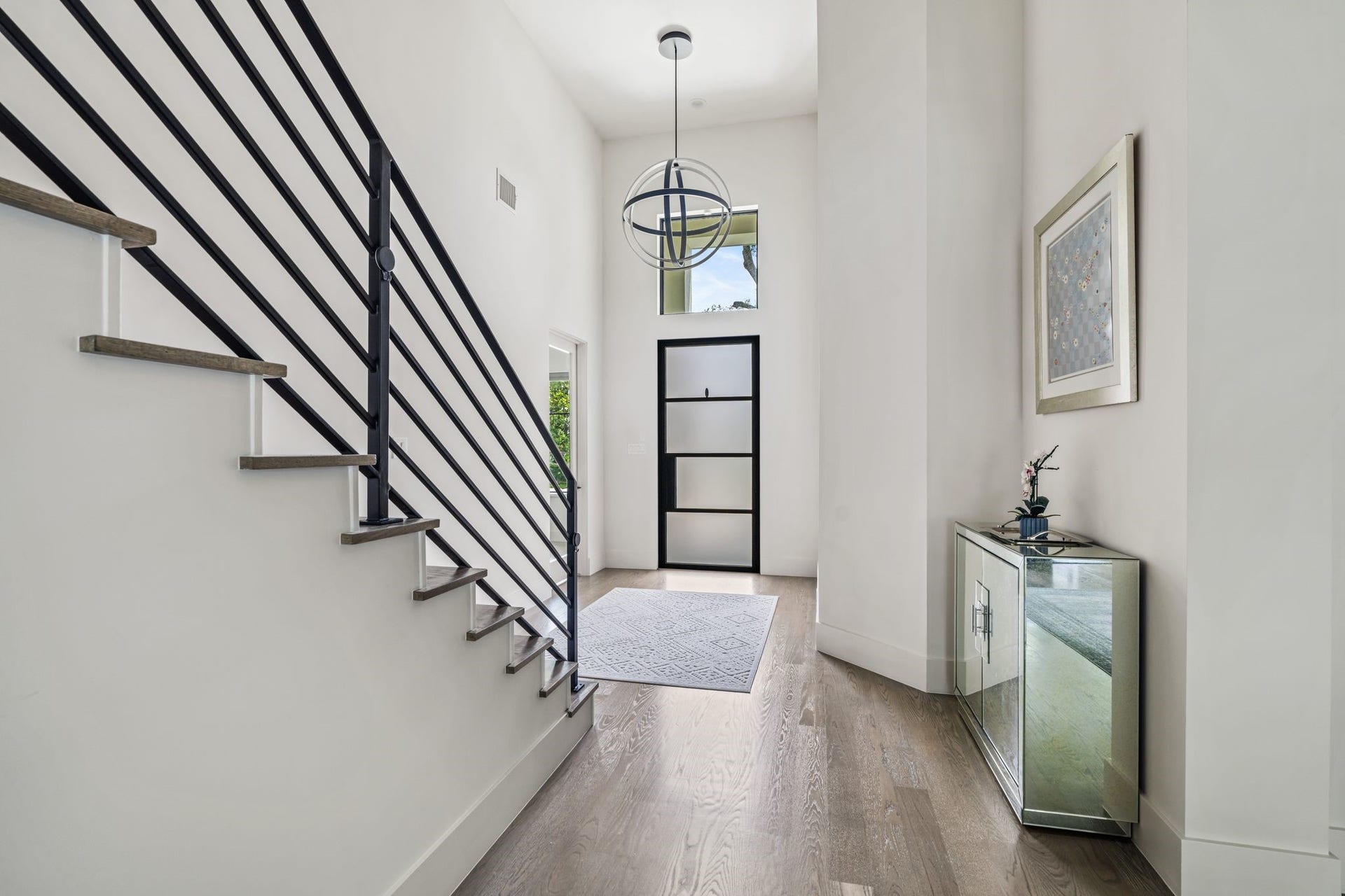 4638 Merwin Street, Houston, TX 77027 Step inside through a custom Durango steel and glass entry door to a bright, welcoming entryway showcasing soaring ceilings, wide plank wood flooring & an airy atmosphere that carries throughout the home.