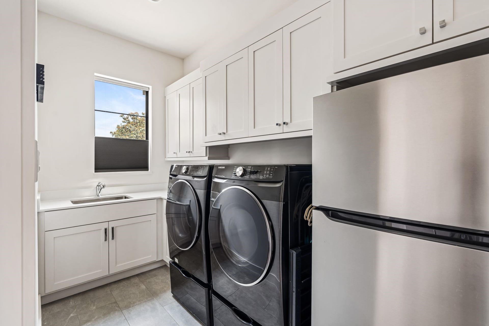 4638 Merwin Street, Houston, TX 77027 A well-appointed utility room offers built-in cabinetry, a utility sink, and plenty of storage.