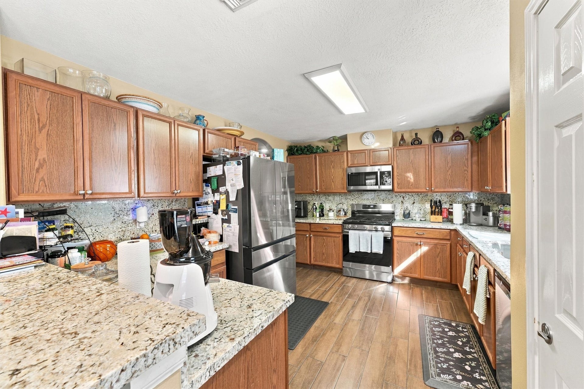 18931 Bonners Park Circle, Katy, TX 77449 Spacious kitchen featuring granite countertops, stainless steel appliances, and ample wooden cabinetry for storage.