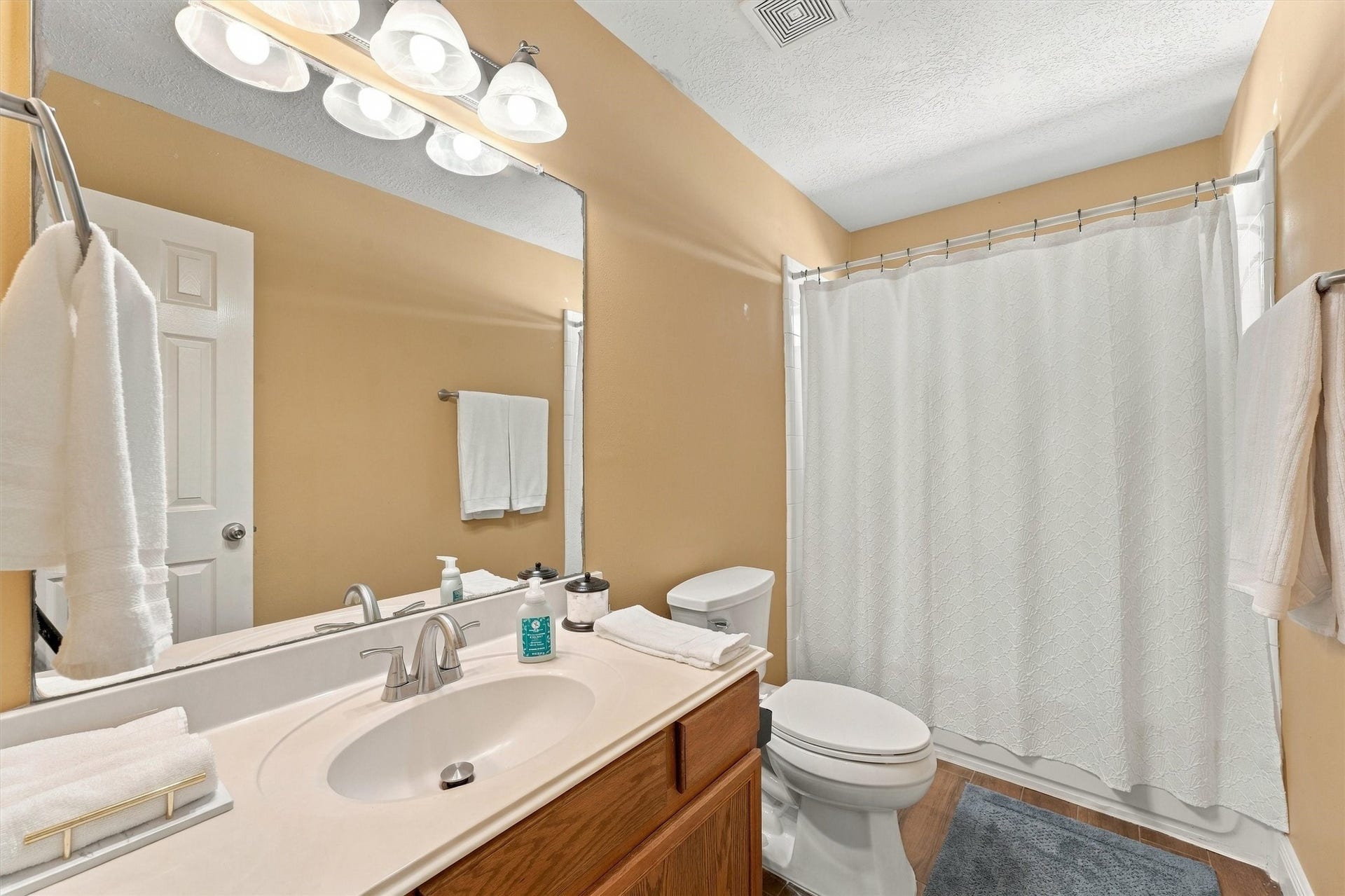 18931 Bonners Park Circle, Katy, TX 77449 Bright and inviting bathroom featuring a spacious vanity with a large mirror, and modern lighting.