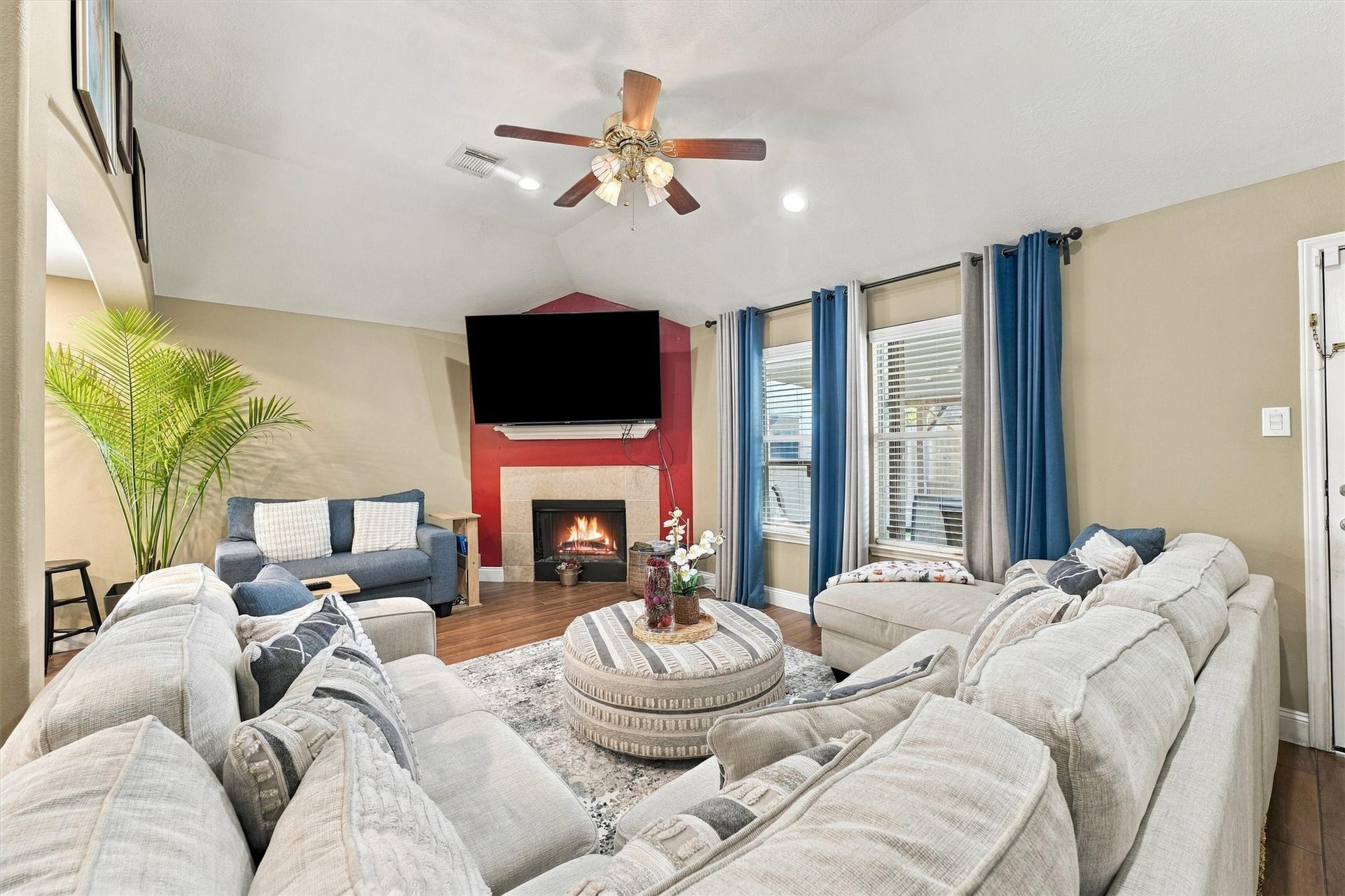 18931 Bonners Park Circle, Katy, TX 77449 Spacious living room with cozy fireplace, vaulted ceiling, and abundant natural light.