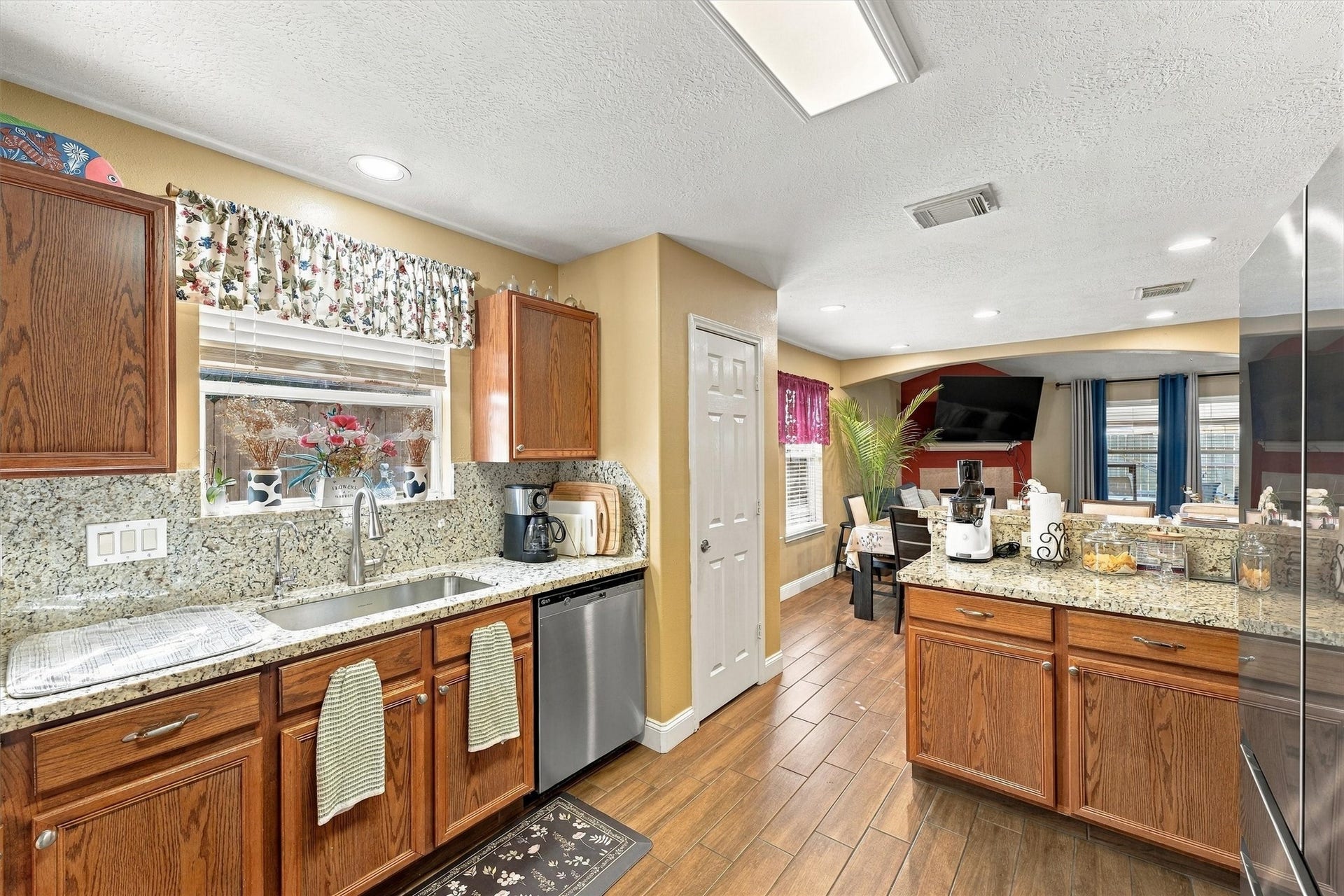 18931 Bonners Park Circle, Katy, TX 77449 Charming kitchen with granite countertops, warm wood cabinetry, and a cozy dining area, perfect for family gatherings.