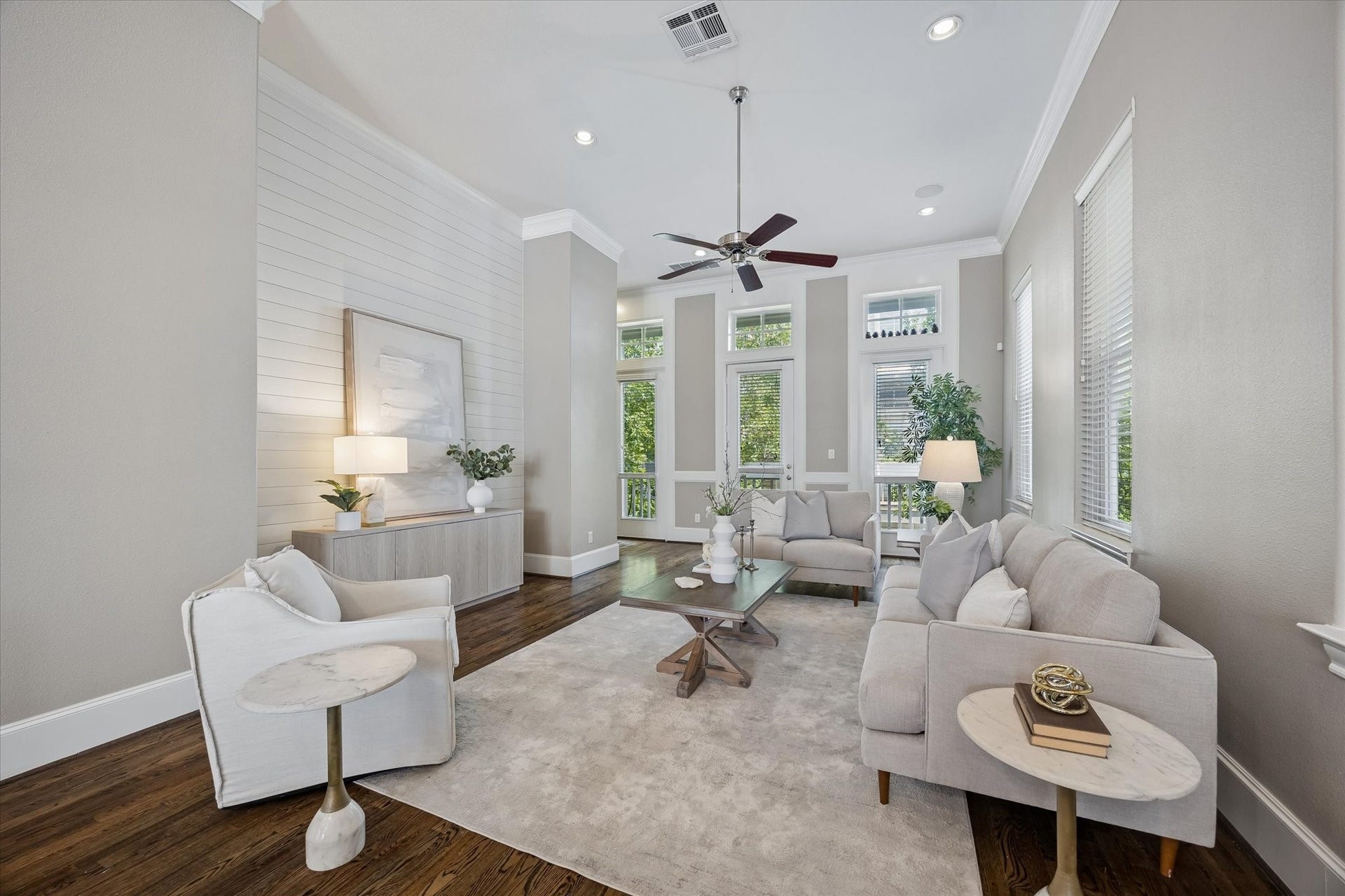 8805 Kolbe Bend Lane, Houston, TX 77080 Comfortable living area framed by tall windows and a glass door leading to the second-floor balcony.