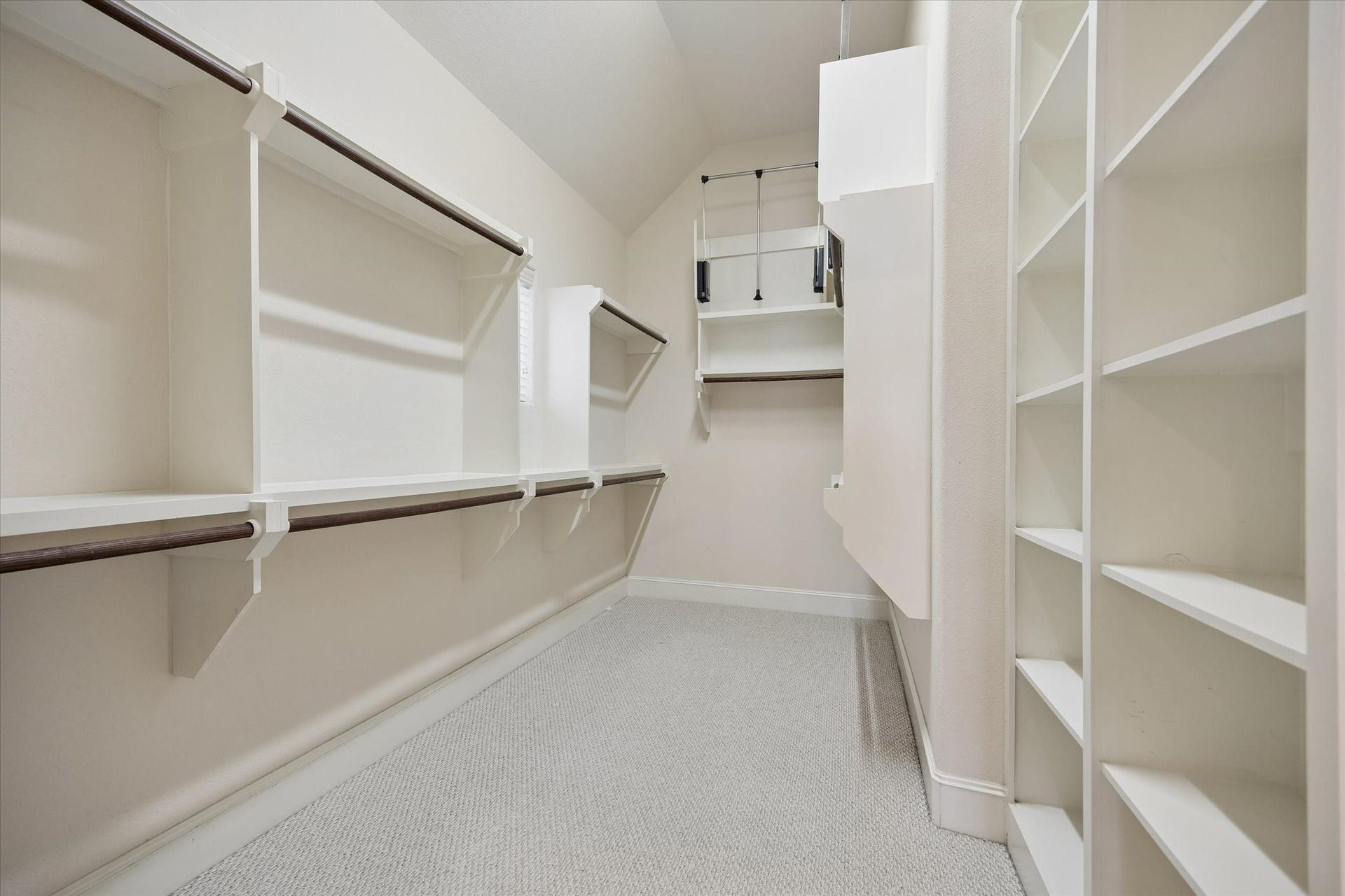 8805 Kolbe Bend Lane, Houston, TX 77080 Oversized primary walk-in closet with extensive built-in shelving, hanging space, and multiple storage configurations.