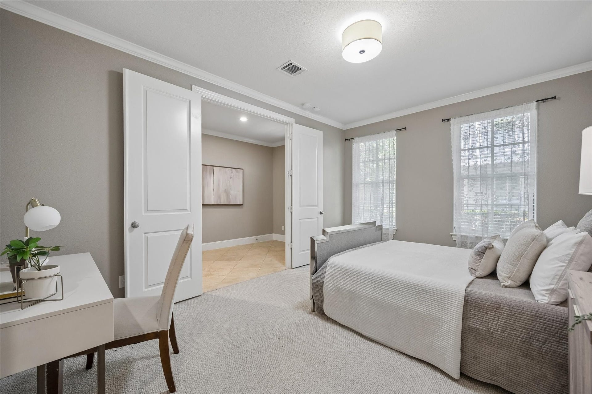 8805 Kolbe Bend Lane, Houston, TX 77080 Spacious secondary bedroom located on the first floor that can double as an office. Two large windows, crown molding, neutral finishes, and direct access to the adjoining bath area.