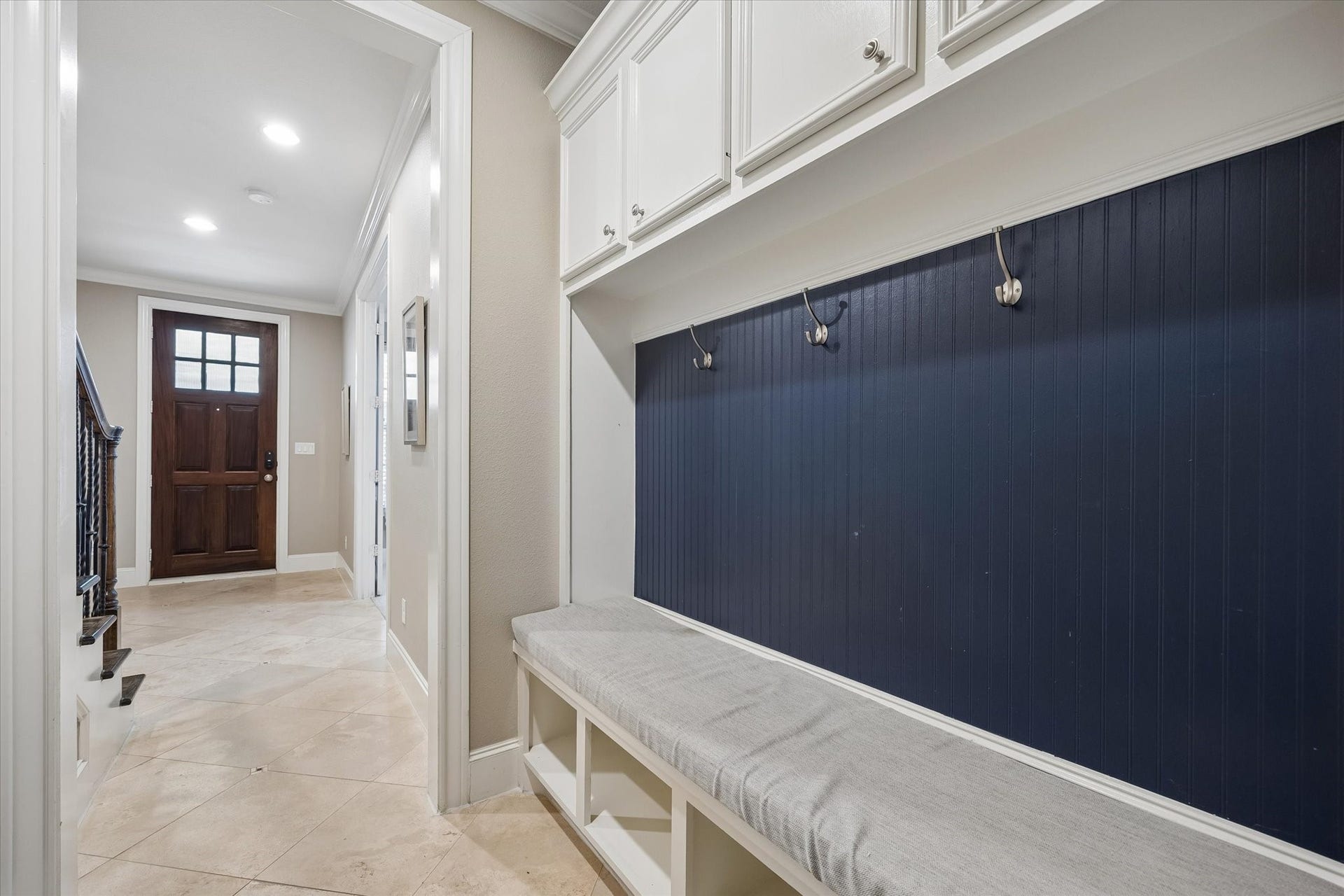8805 Kolbe Bend Lane, Houston, TX 77080 Welcoming first-floor entry with built-in bench, storage cabinetry and custom accent wall.