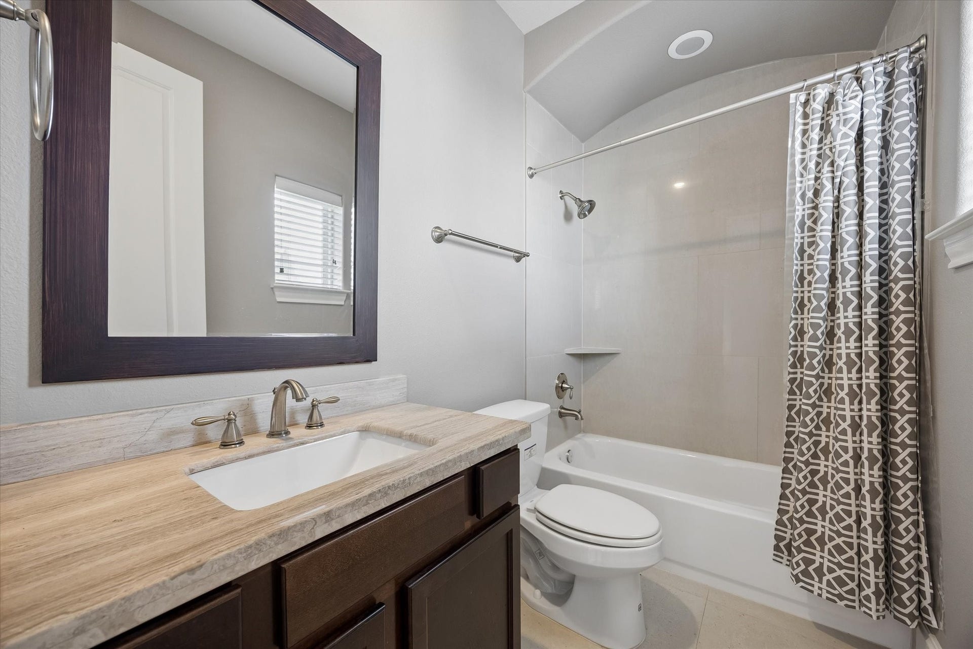 8805 Kolbe Bend Lane, Houston, TX 77080 Full secondary bath with stone countertop, dark wood vanity, tub/shower combination, and tile surround.