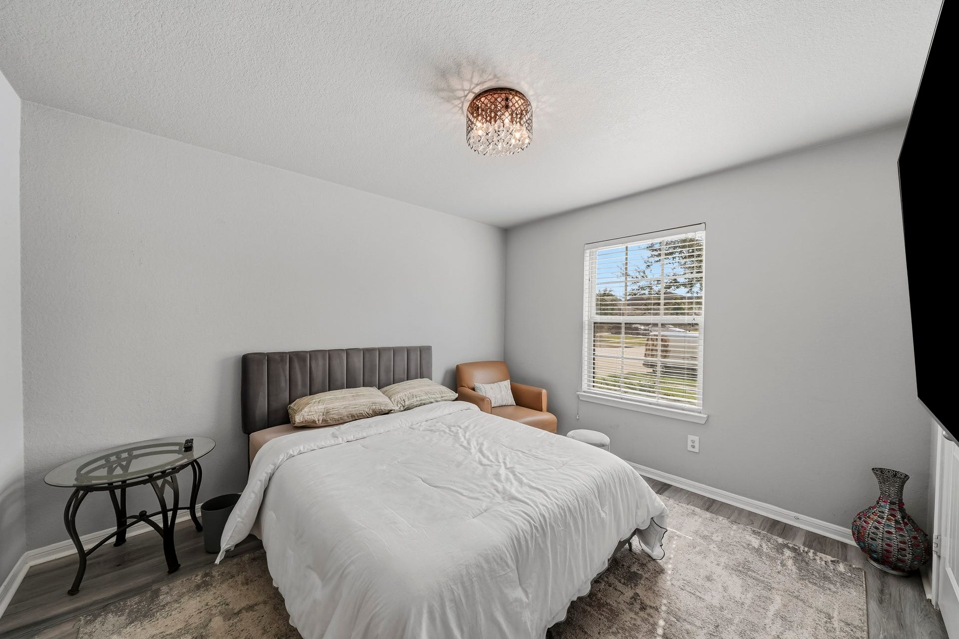 17822 Royal Breccia Lane, Richmond, TX 77407 A thoughtfully furnished bedroom offers a welcoming retreat with soft neutral tones, comfortable furnishings, and natural light.
