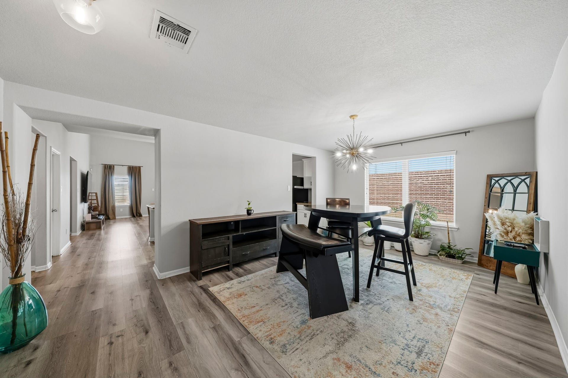 17822 Royal Breccia Lane, Richmond, TX 77407 A bright and inviting dining space features contemporary lighting, stylish furnishings, and an open layout ideal for everyday meals or gathering with friends.