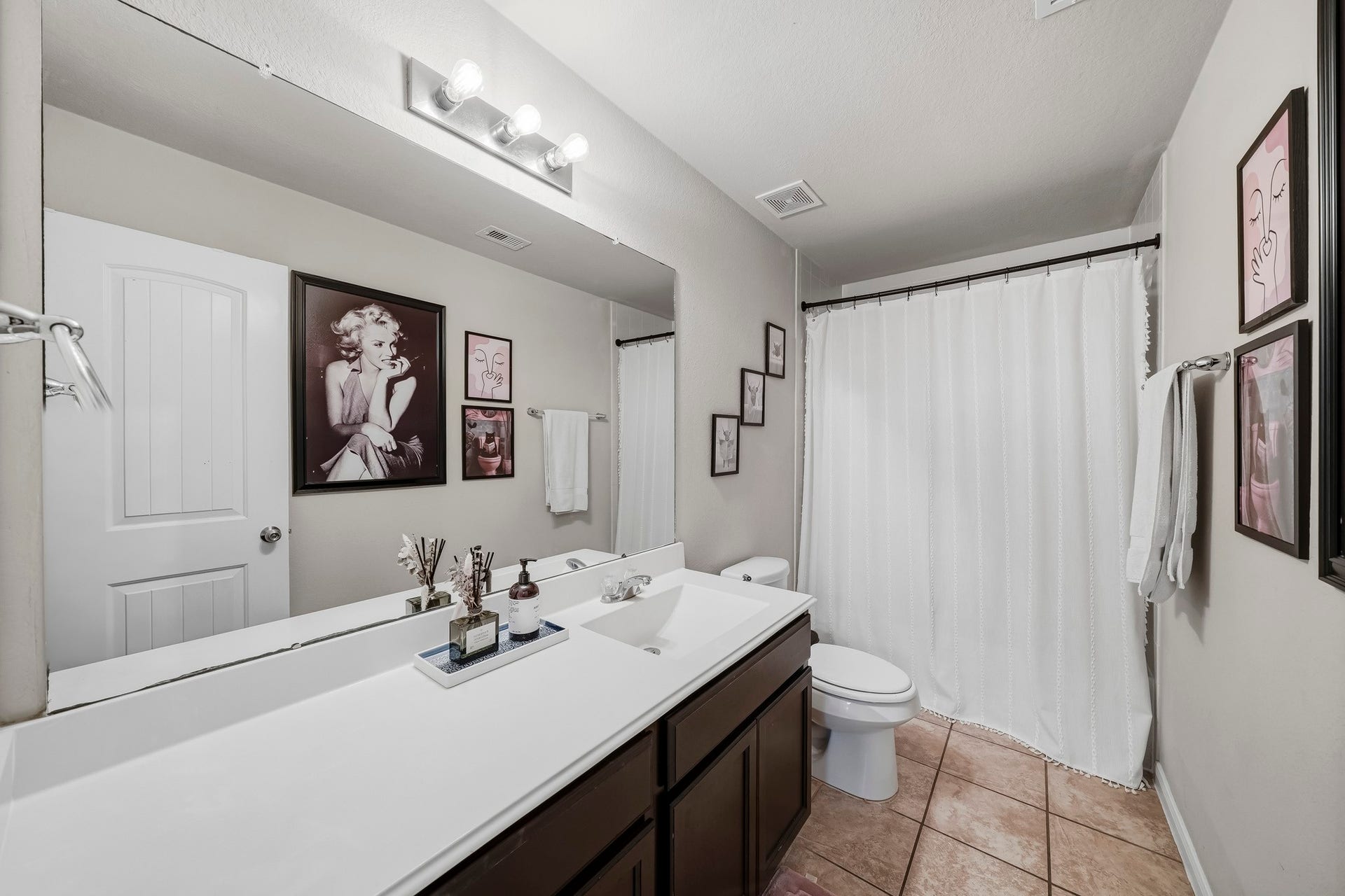 17822 Royal Breccia Lane, Richmond, TX 77407 A bright secondary bathroom features an extended vanity, generous counter space, and a shower and tub combination.