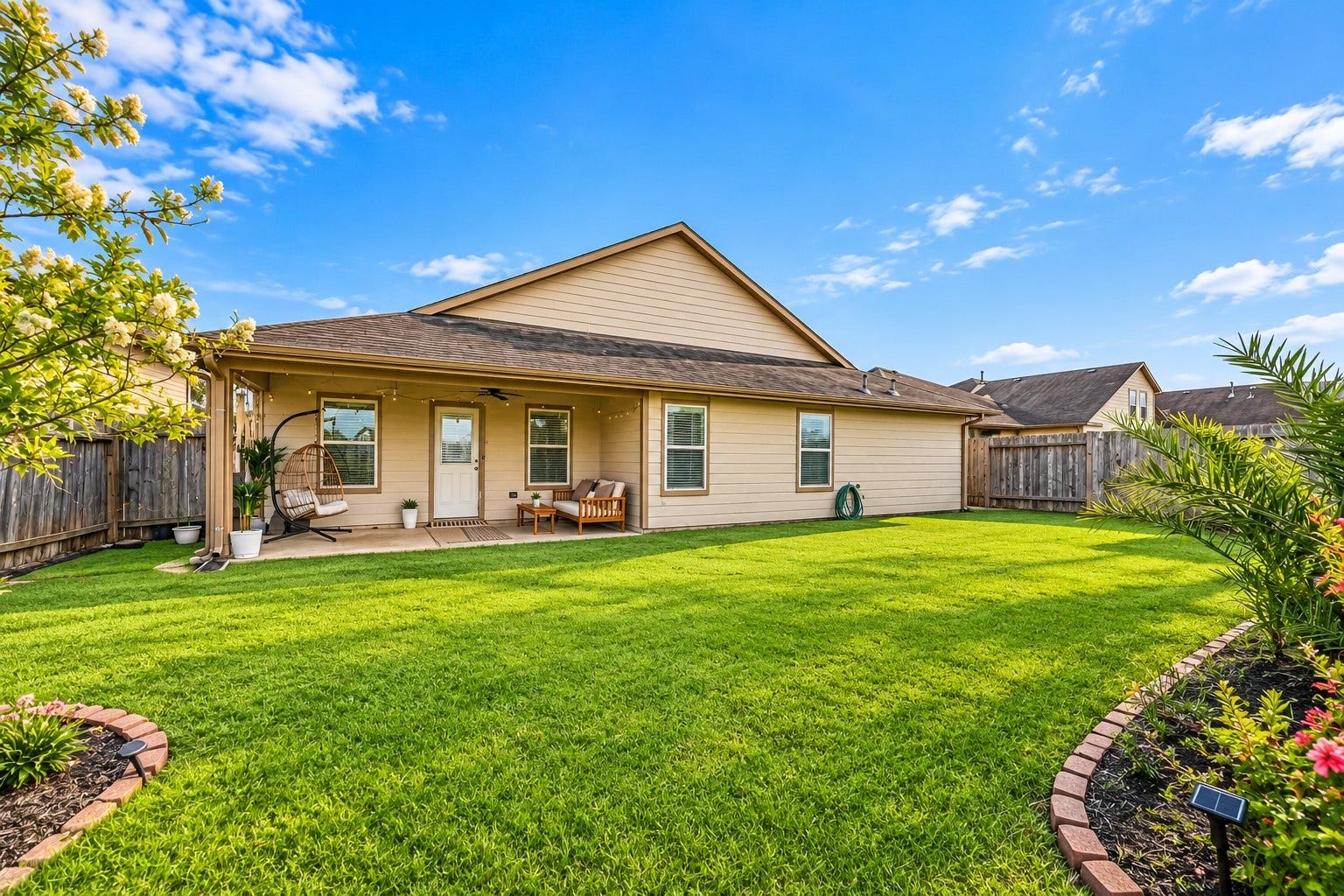 17822 Royal Breccia Lane, Richmond, TX 77407 Enjoy a spacious, private backyard with a covered patio, inviting seating area, and plenty of green space for relaxing outdoors, entertaining, or enjoying a quiet afternoon at home.