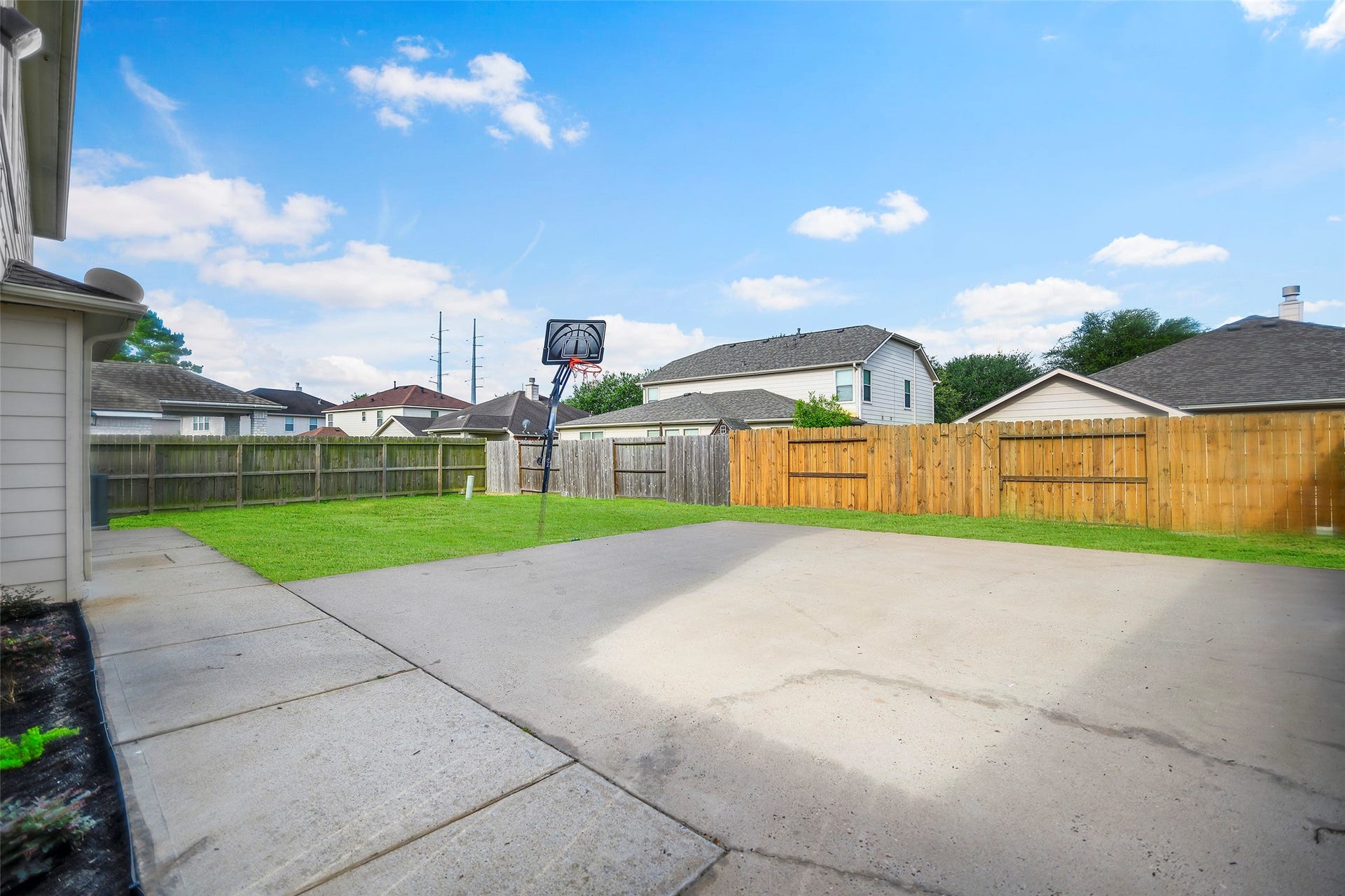 Massive backyard with extended patio and basketball half court