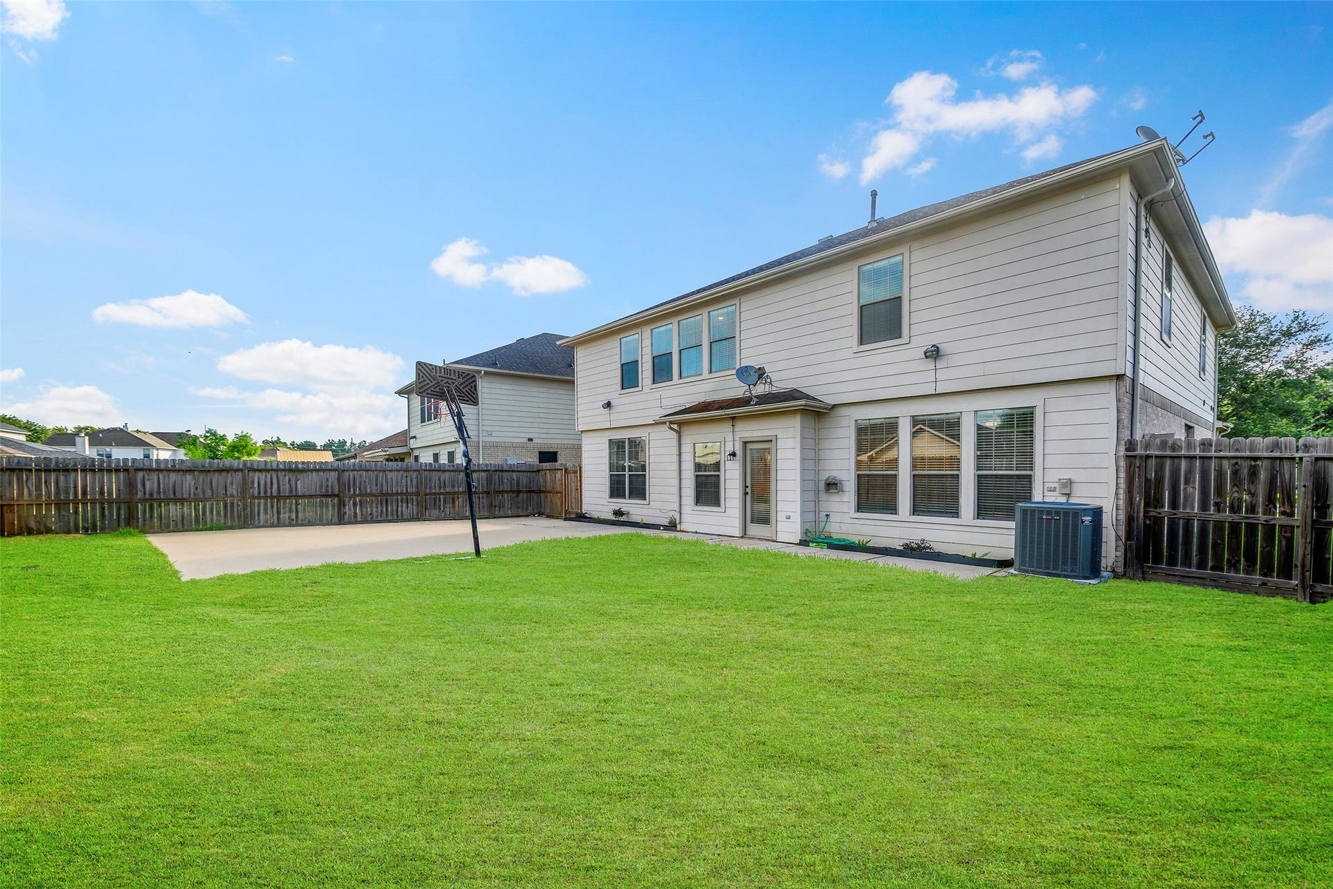 Massive backyard with extended patio and basketball half court