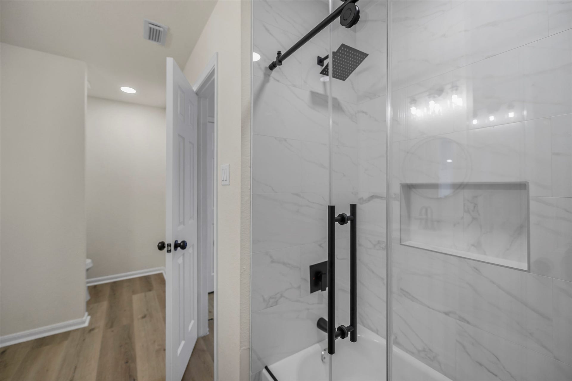 Secondary Bathroom. New cabinets, countertops, shower, tub, and fixtures.