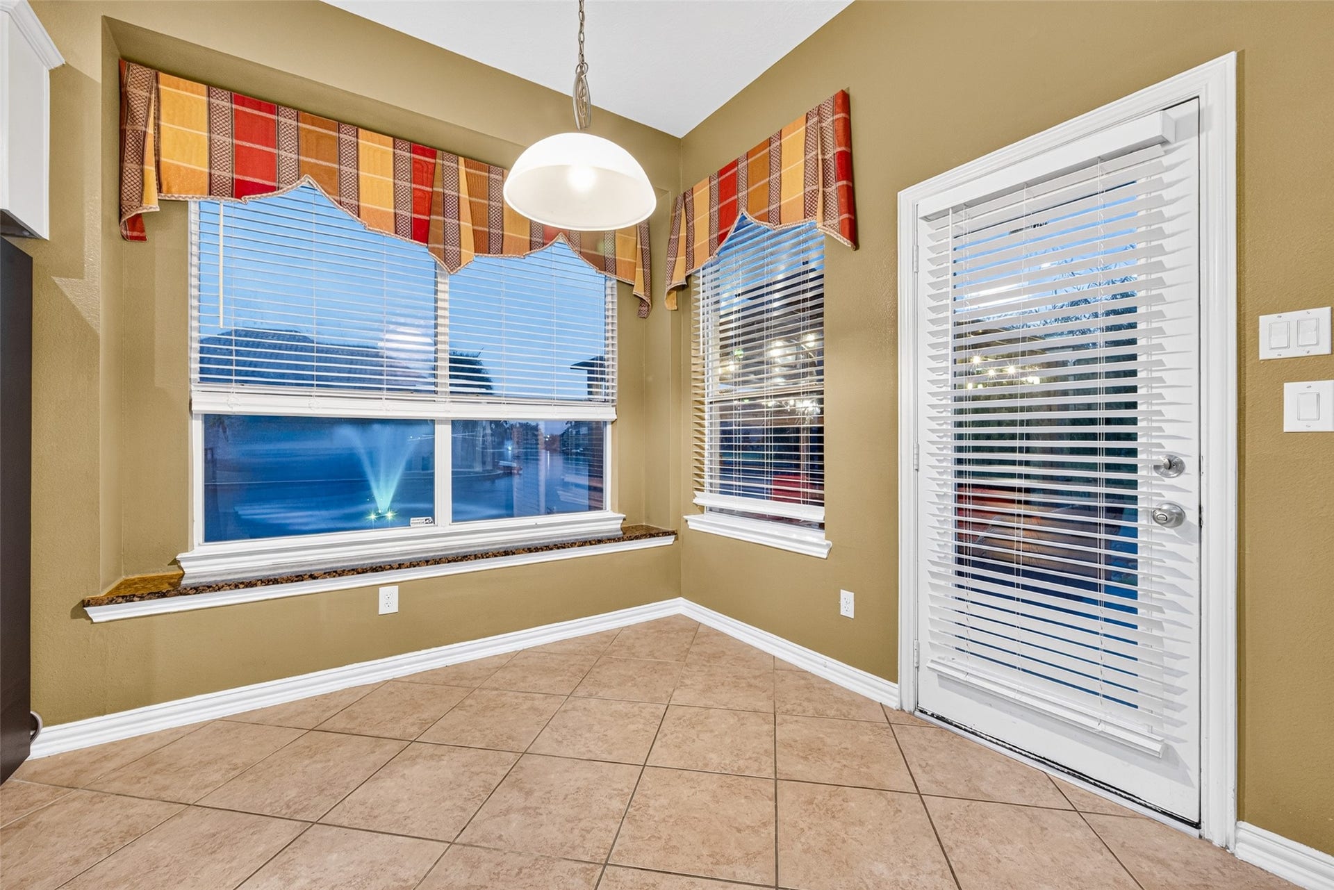 14242 Ashmore Reef Court, Sugar Land, TX 77498 Cozy breakfast area featuring large windows that fill the space with natural light and direct access to the outdoor patio, creating a seamless connection between indoor dining and outdoor living