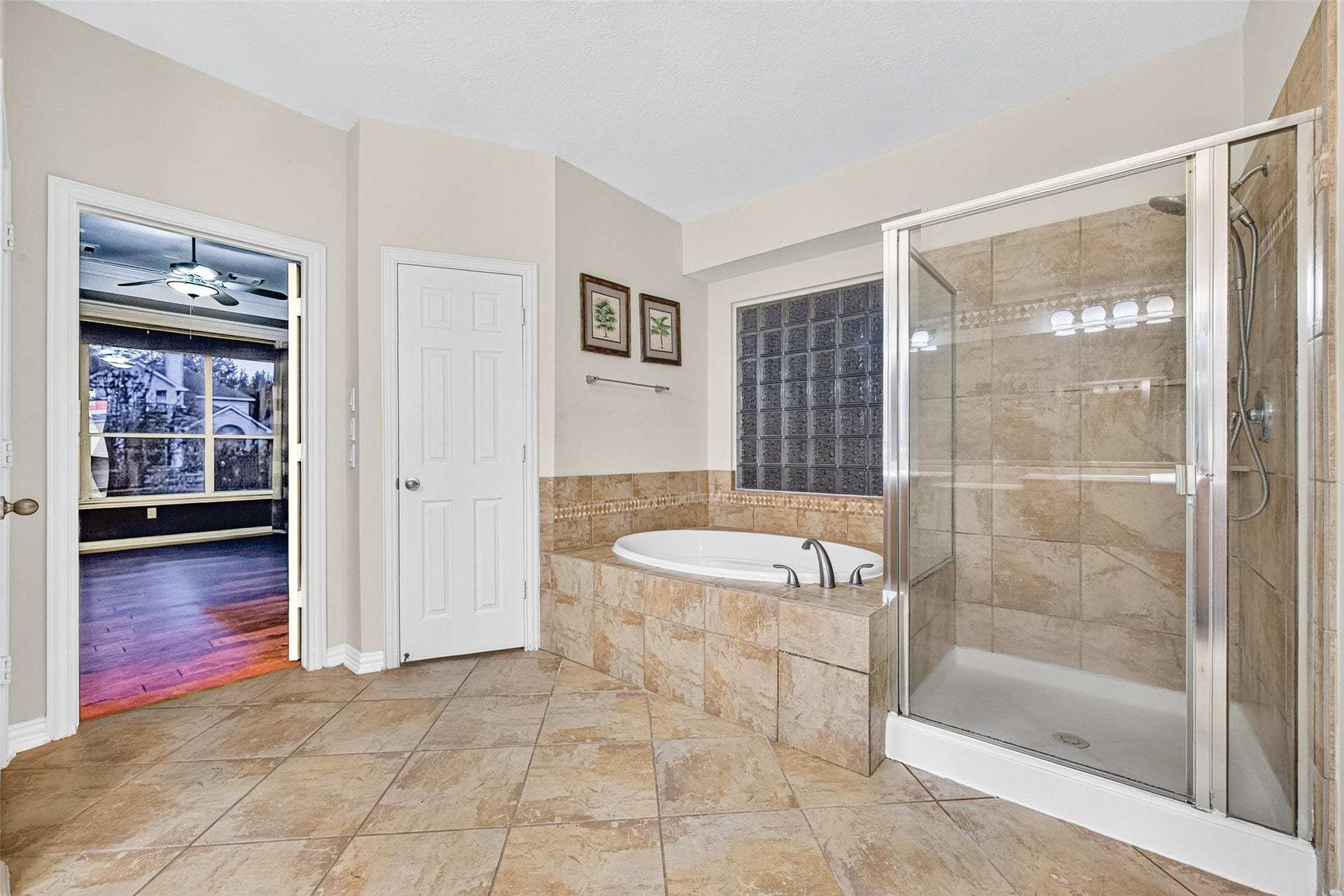 14242 Ashmore Reef Court, Sugar Land, TX 77498 Luxurious primary en-suite featuring a spacious walk-in shower, relaxing soaking tub, and elegant double vanities, creating a sophisticated spa-inspired retreat