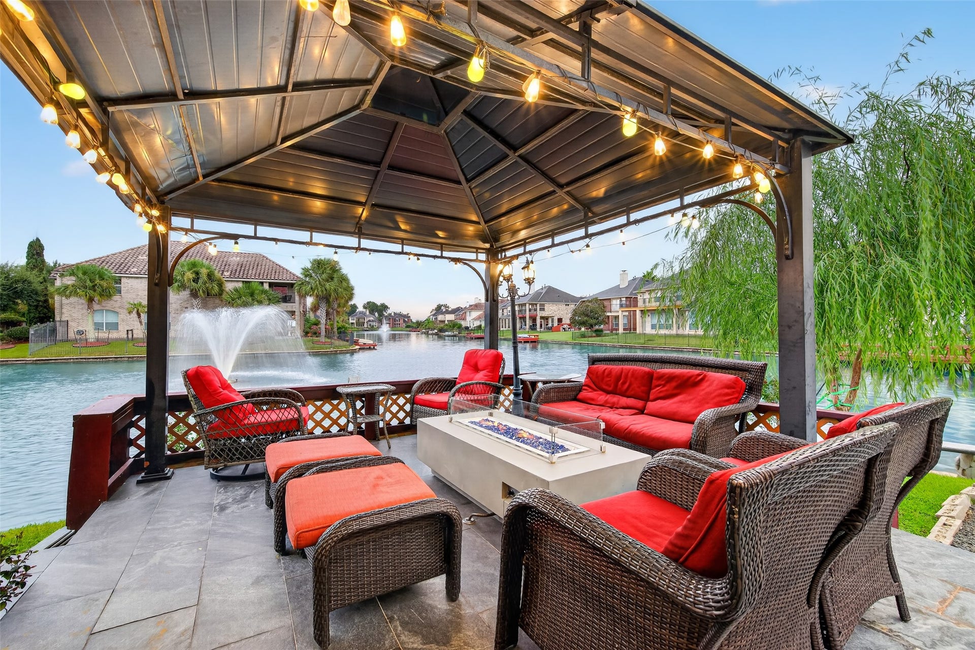 14242 Ashmore Reef Court, Sugar Land, TX 77498 Breathtaking lakefront outdoor patio offering a serene setting for relaxing, entertaining, and enjoying picturesque waterfront views in the comfort of your own backyard