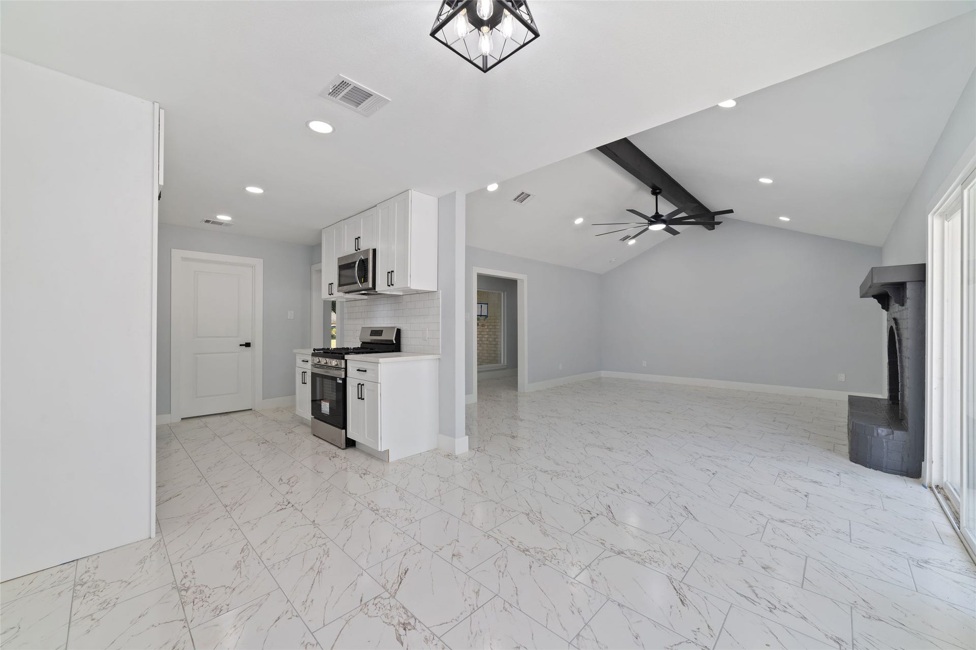 This view highlights the connection between the kitchen, dining area, and living room, bringing everyday cooking, dining, and gathering spaces together.
