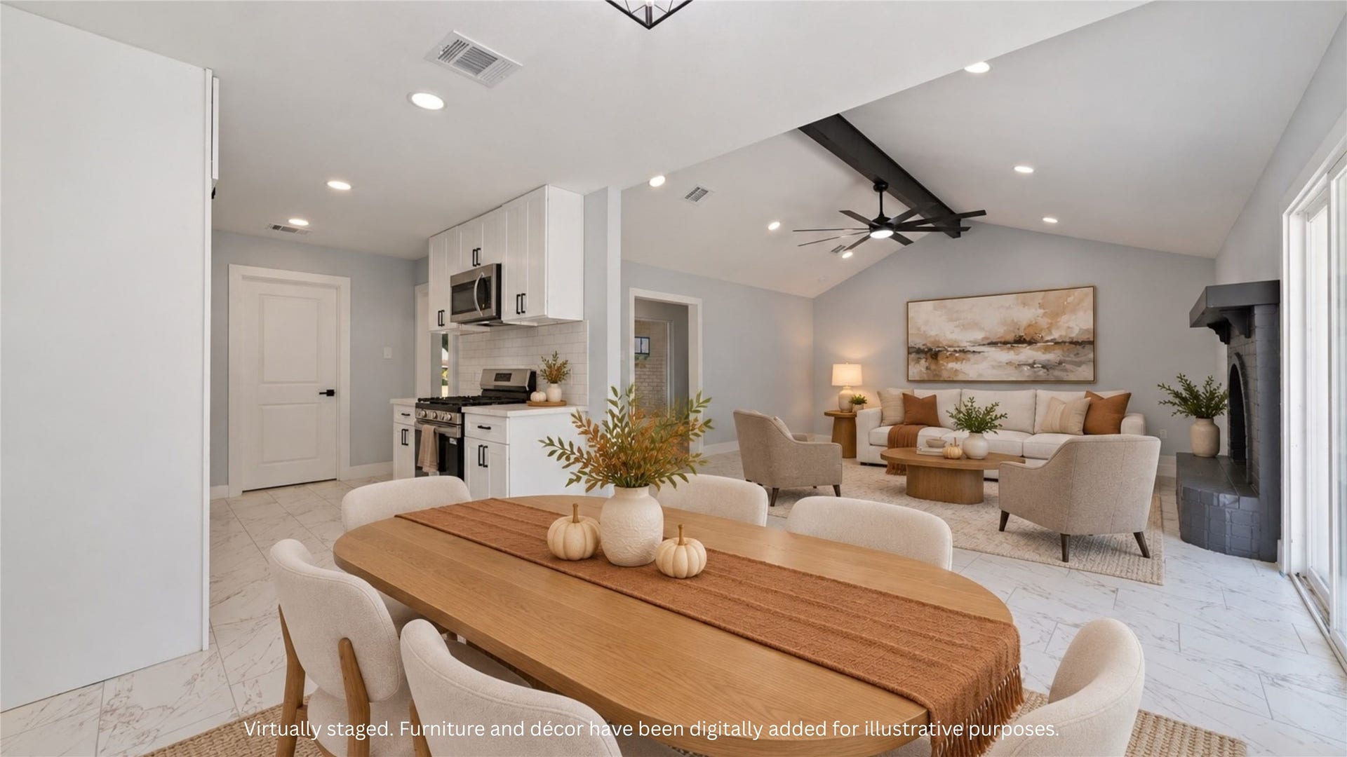 Virtually staged view showing the connection between the dining area, kitchen and living room. Furnishings and dcor digitally added to illustrate a possible layout.