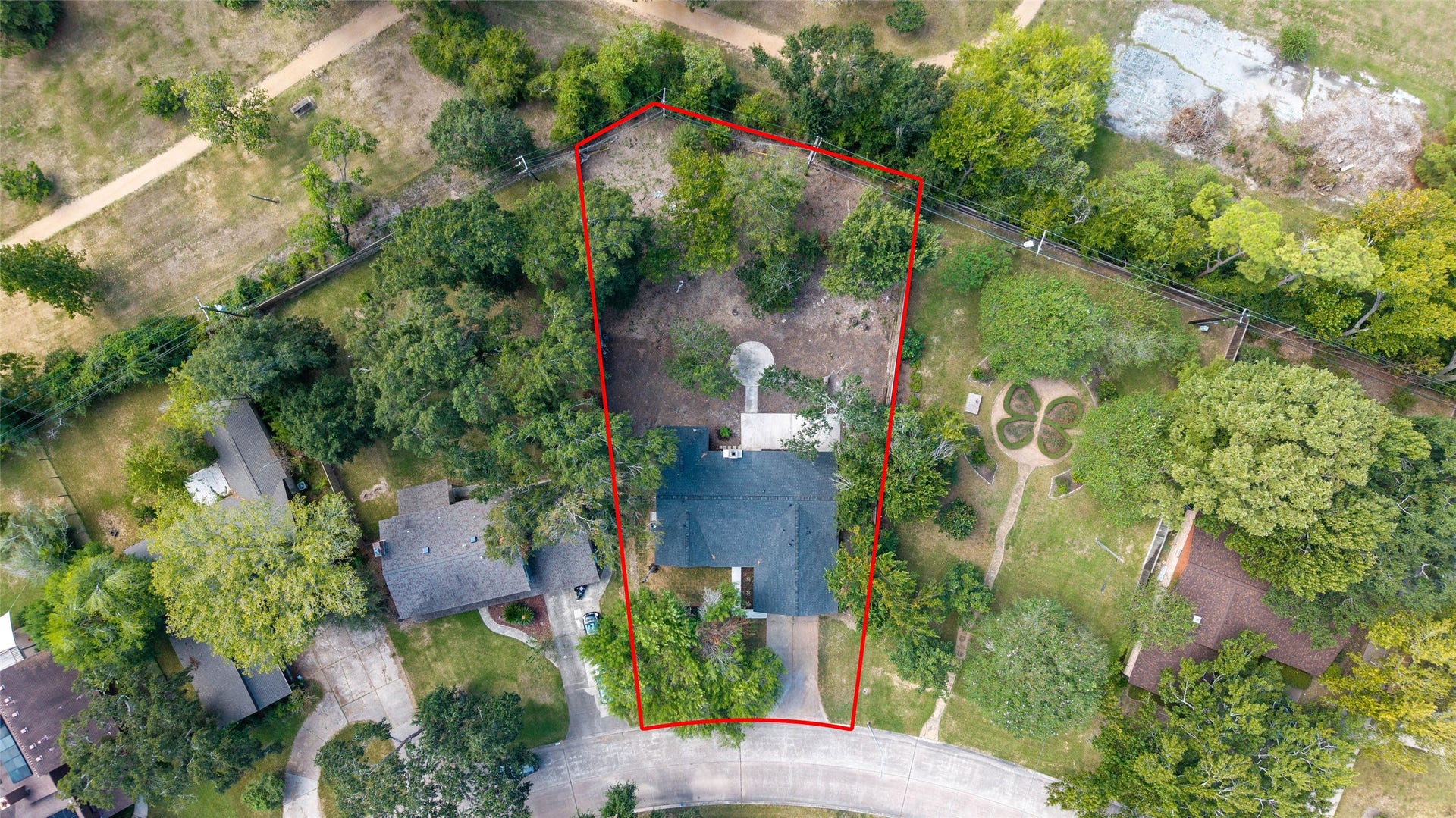 Overhead view showcasing the Park on its tree-filled lot and surrounding landscape visible.
