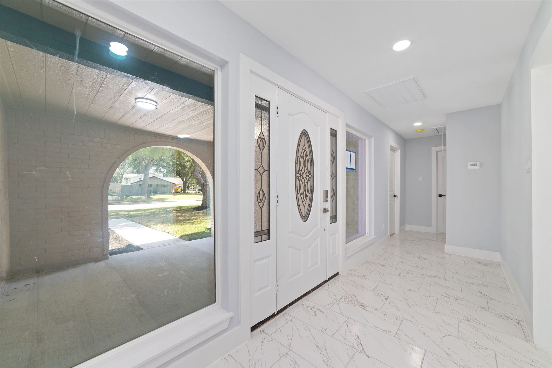 A covered front entry welcomes you inside, where the entry hallway introduces the homes interior.