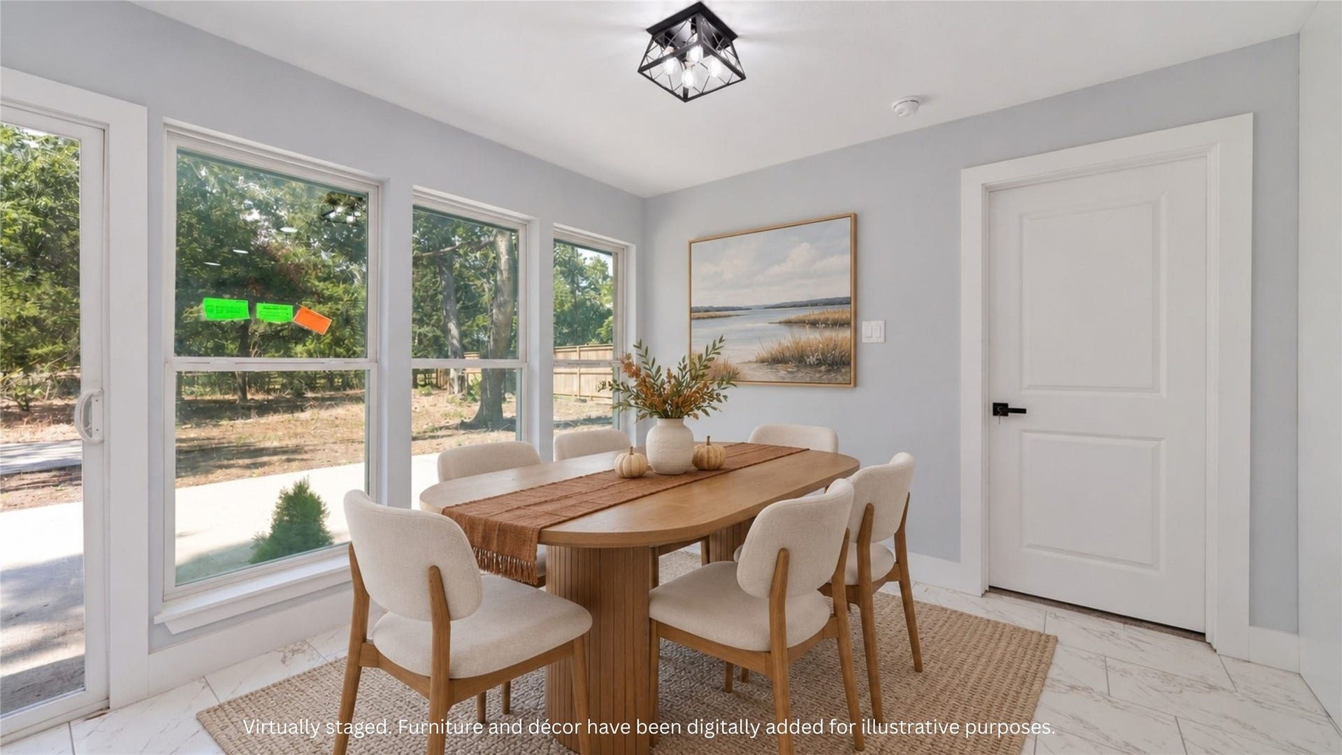 Virtually staged dining area with a proposed table arrangement beside a wall of windows. Furnishings and dcor digitally added for illustration.