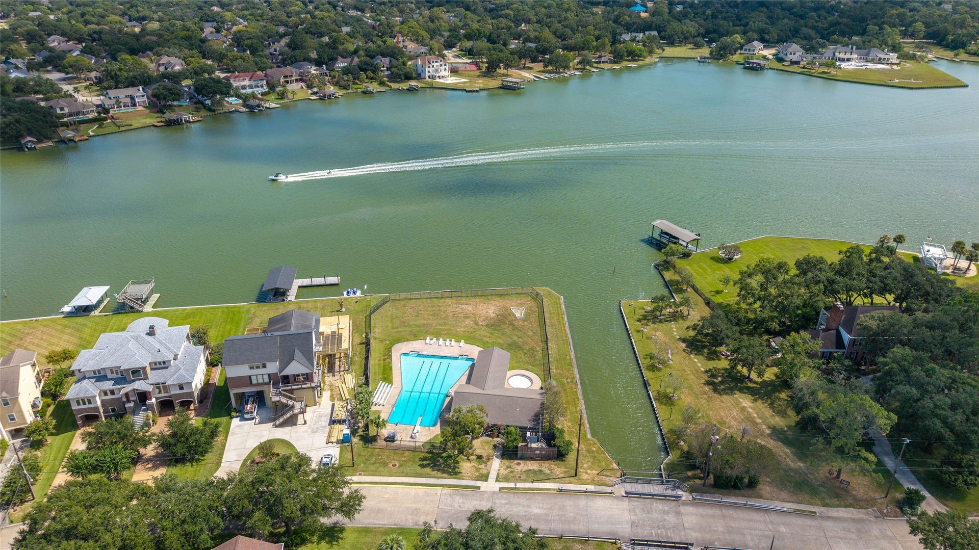 Scenic aerial view of Taylor Lake, showcasing the shoreline, waterfront homes, and surrounding greenery near Timber Cove.