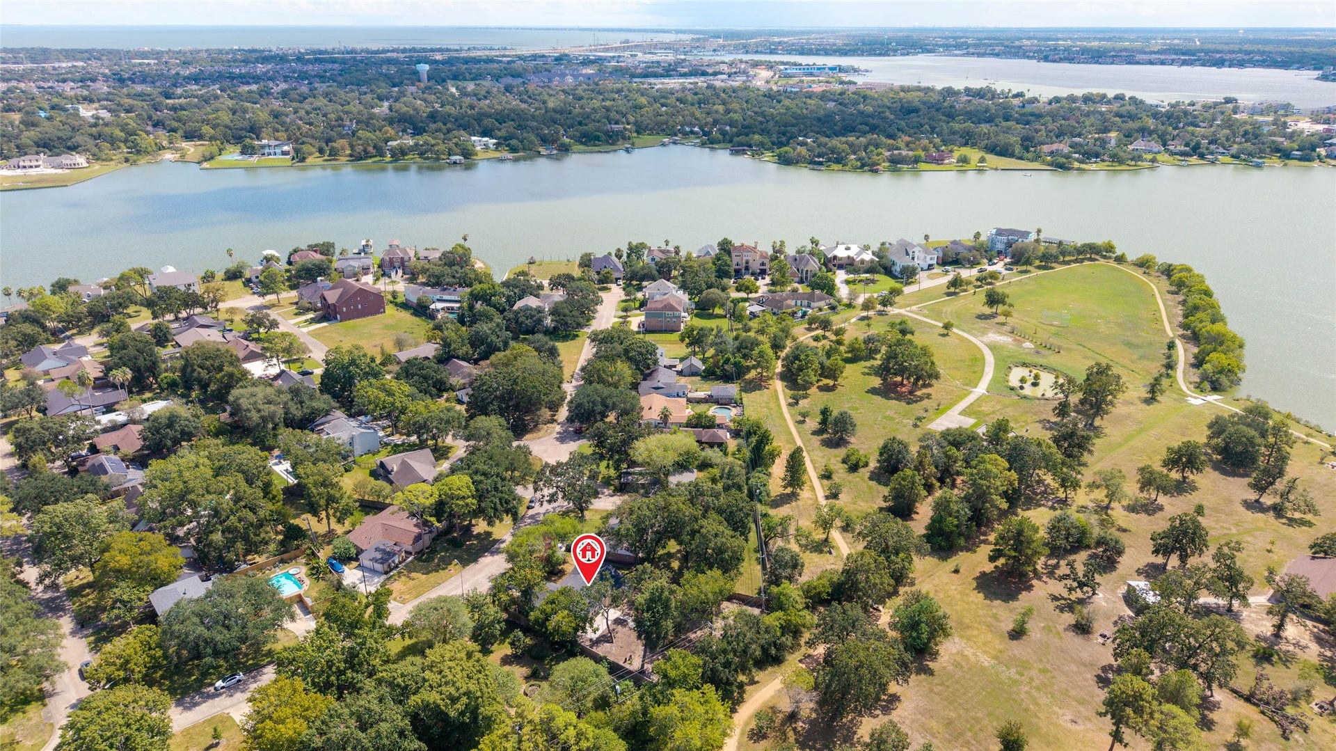 Aerial perspective highlighting the homes location within Timber Cove, surrounded by mature trees and nearby Taylor Lake.