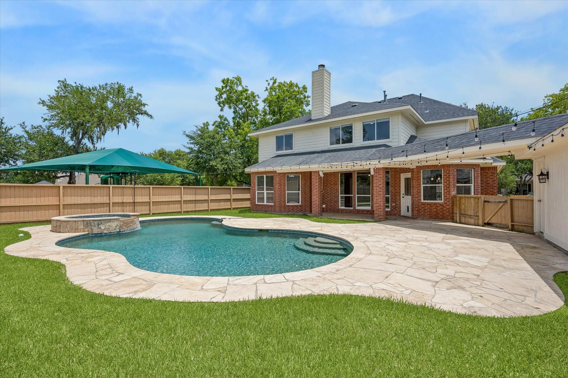 The sparkling pool and raised spa create the perfect setting for relaxing or entertaining outdoors.