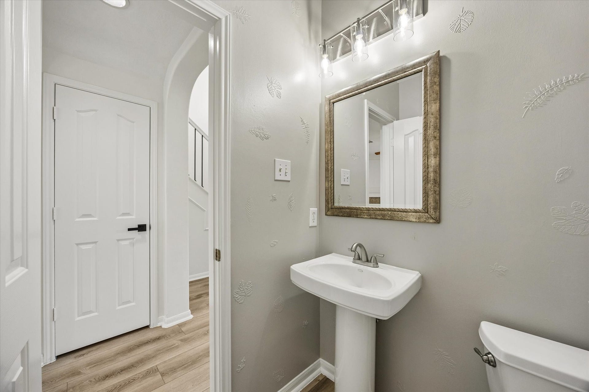 A stylish powder bath adds convenience for guests on the main level.
