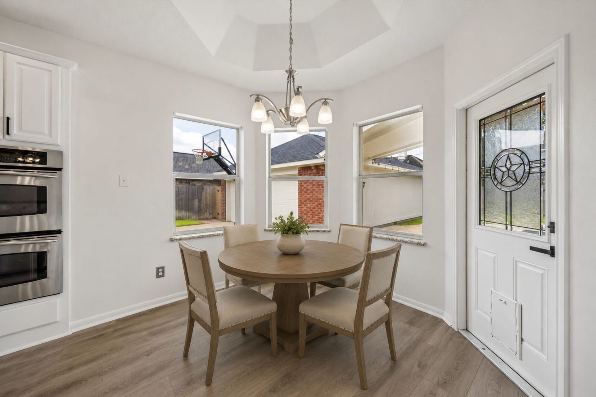 The sunny breakfast nook offers a casual dining space with views of the backyard and easy patio access.