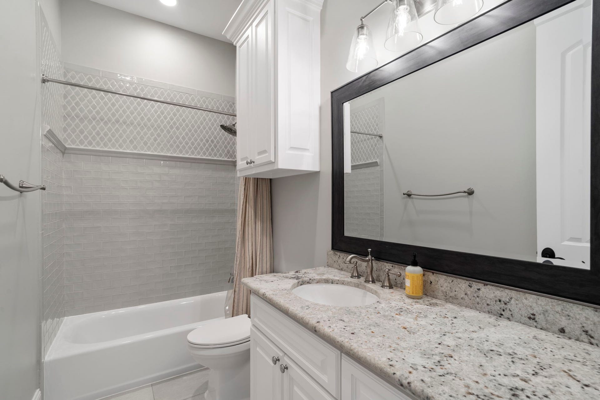 706 Oyster Creek Drive, Sugar Land, TX 77478 This home offers four full bathrooms and one half bath, including this full bathroom conveniently located on the first floor.