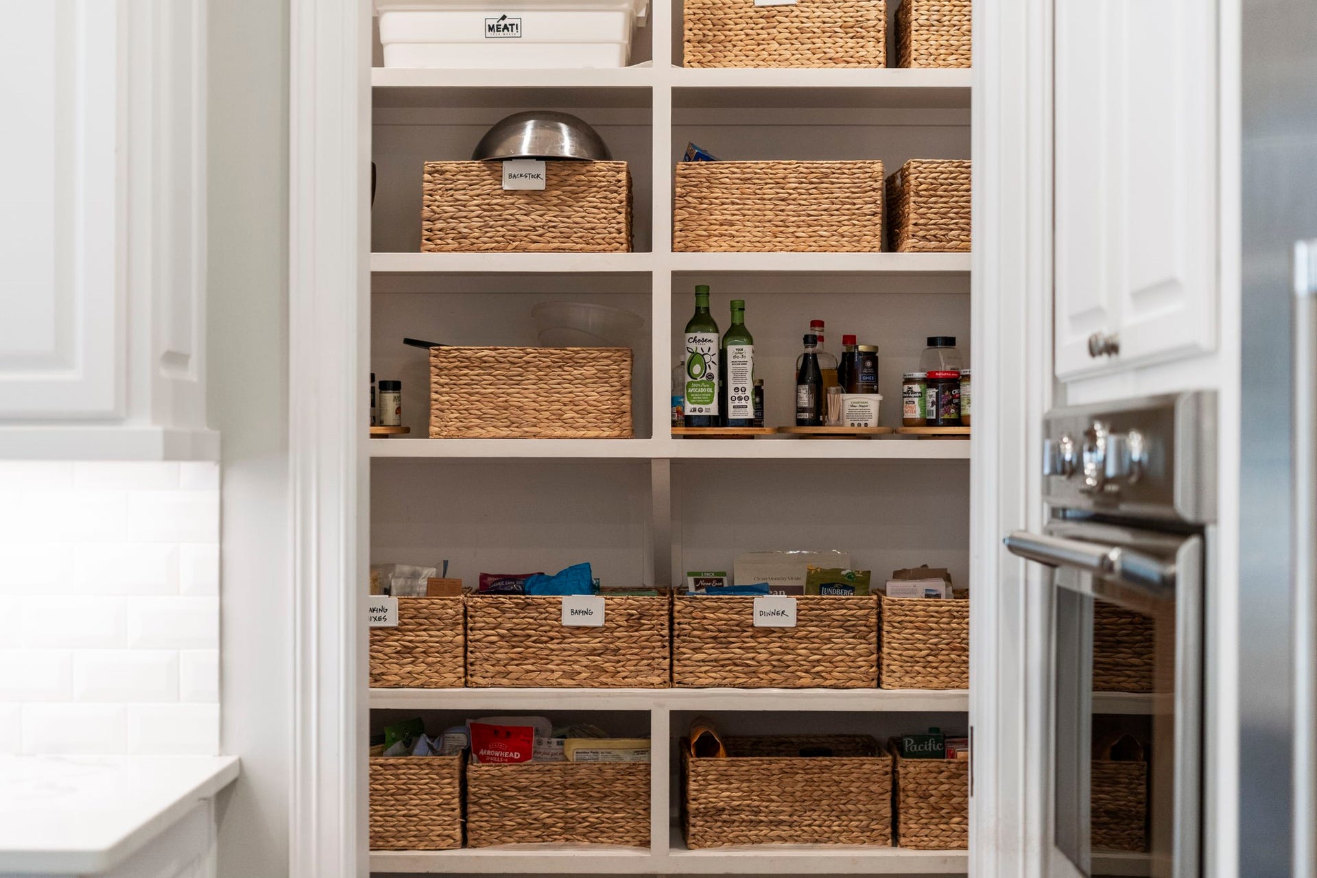 706 Oyster Creek Drive, Sugar Land, TX 77478 A huge walk-in kitchen pantry is tucked behind a space-saving pocket door and features floor-to-ceiling shelving that maximizes every inch of space, keeping kitchen essentials organized and easily accessible.