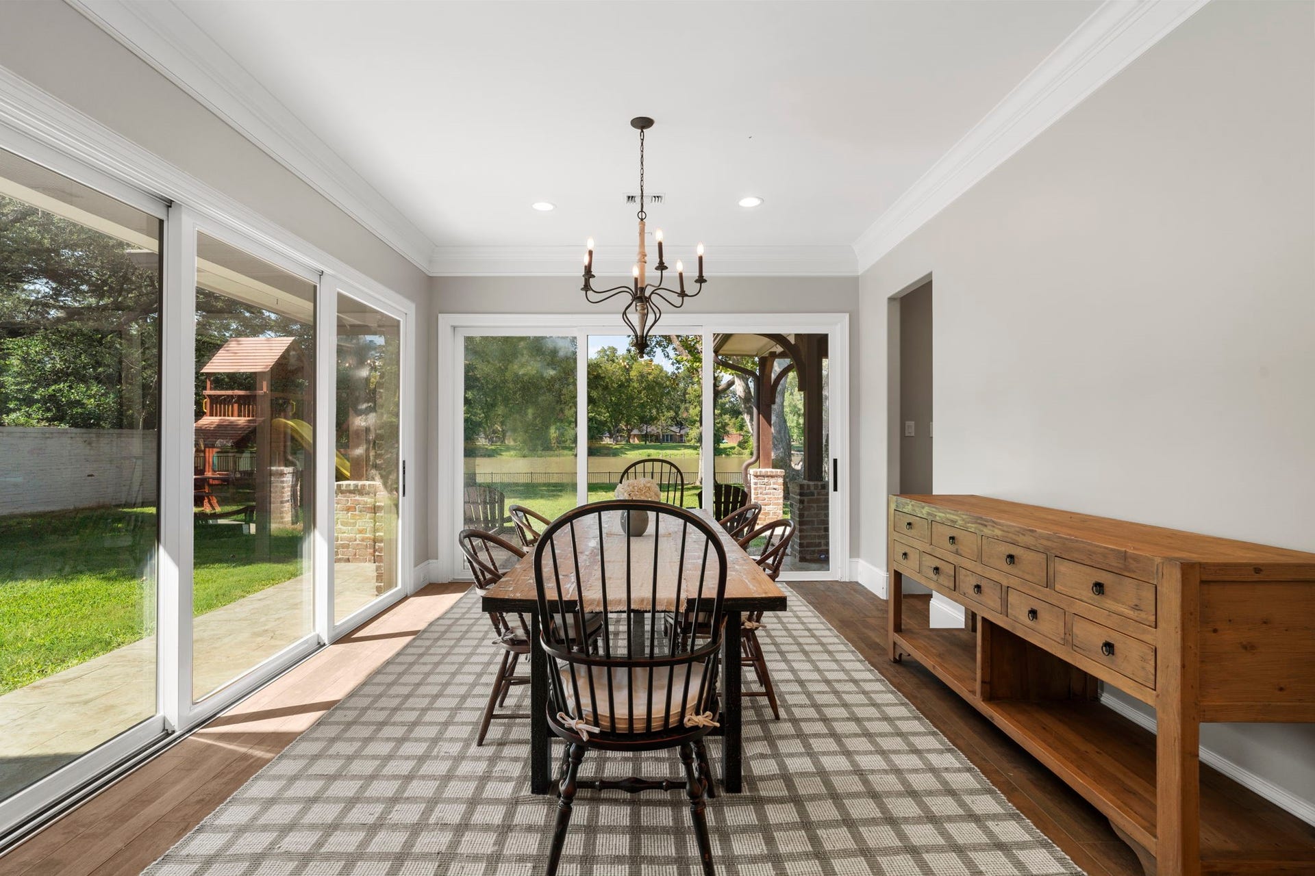 706 Oyster Creek Drive, Sugar Land, TX 77478 A fresh take on the traditional dining room, this light-filled space features floor-to-ceiling windows and sliding glass doors on two walls, framing beautiful views of the backyard and Oyster Creek.