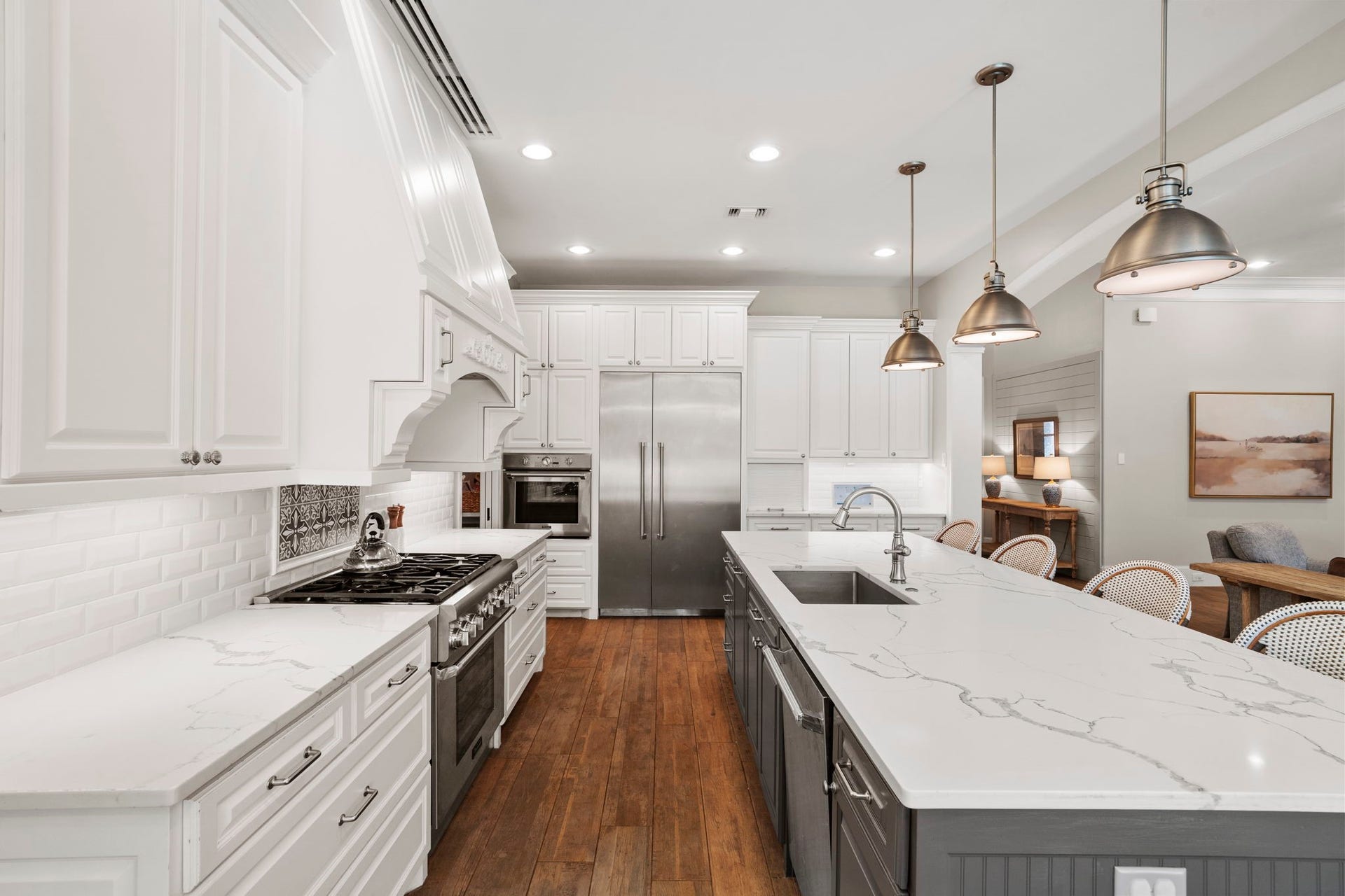 706 Oyster Creek Drive, Sugar Land, TX 77478 Quartz countertops are paired with a white subway tile backsplash, creating a timeless, fresh look that is both durable and versatile.