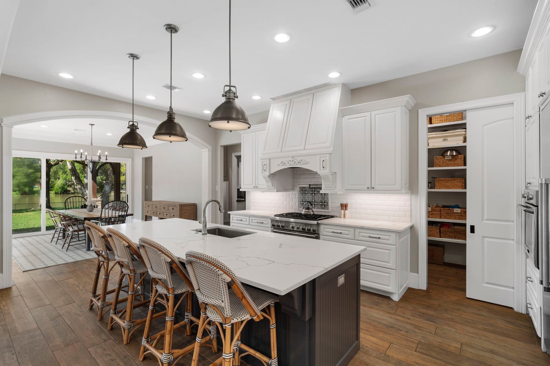 706 Oyster Creek Drive, Sugar Land, TX 77478 A generously sized breakfast bar serves as a centerpiece of the kitchen, offering seating and workspace for casual meals, morning coffee, entertaining, and gatherings with family and friends.
