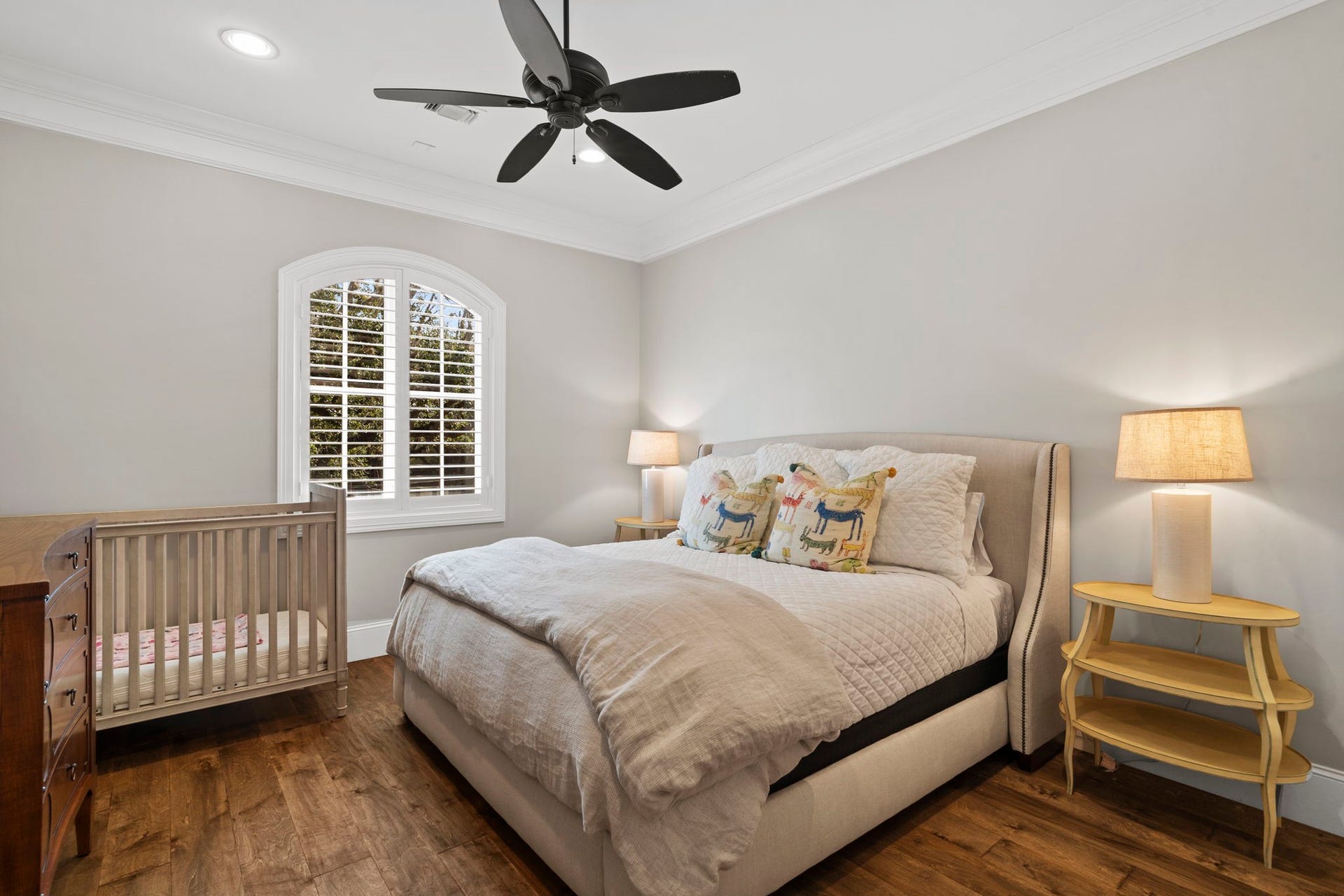 706 Oyster Creek Drive, Sugar Land, TX 77478 Beautiful trimwork, including detailed baseboards and crown molding, adds a polished finish to this second-floor bedroom, which features a walk-in closet and en suite Hollywood-style bathroom.