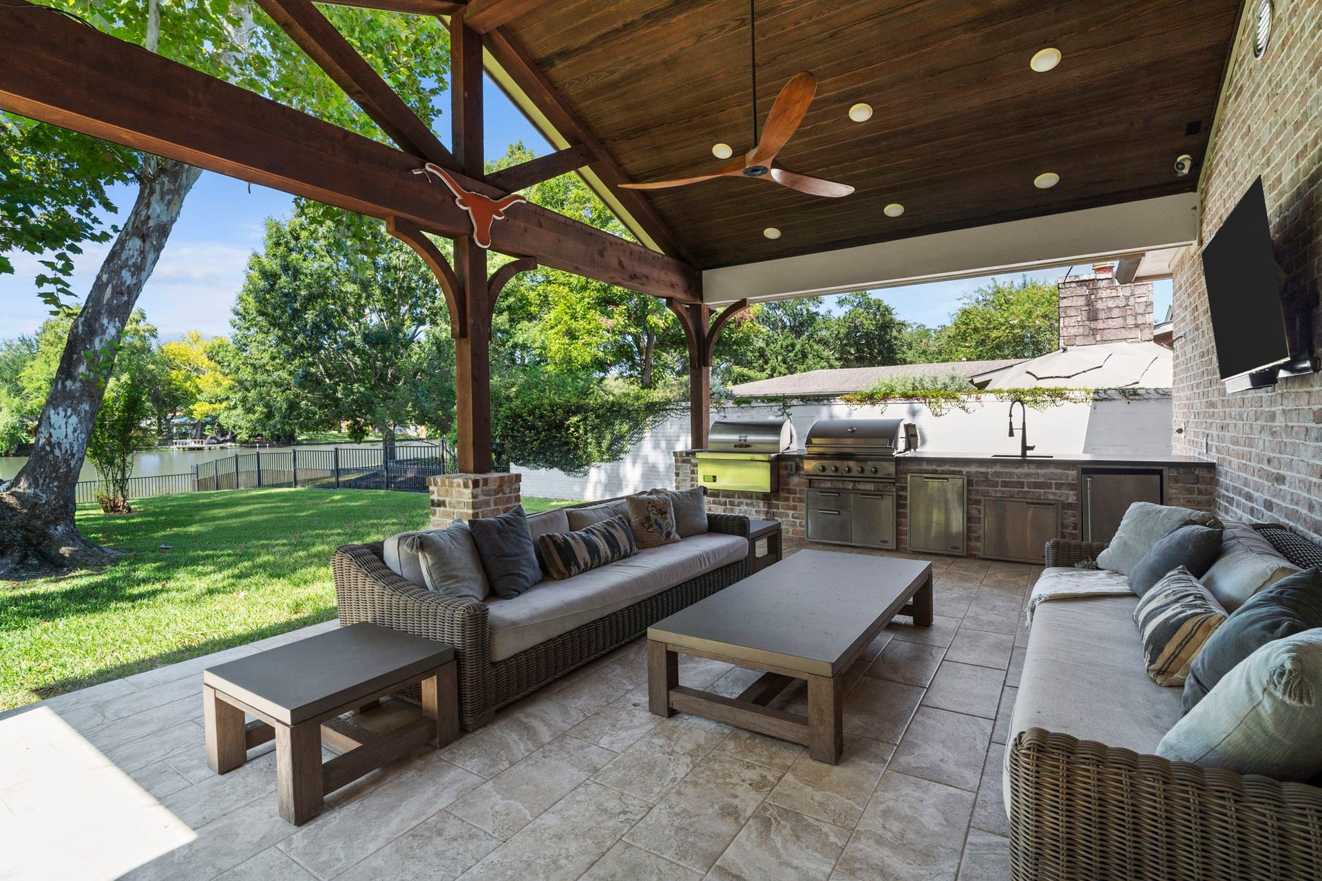 706 Oyster Creek Drive, Sugar Land, TX 77478 Designed for indoor-outdoor entertaining, the covered patio features a fully-equipped kitchen with a 36-inch DCS gas grill, sink, refrigerator, and side griddle.
