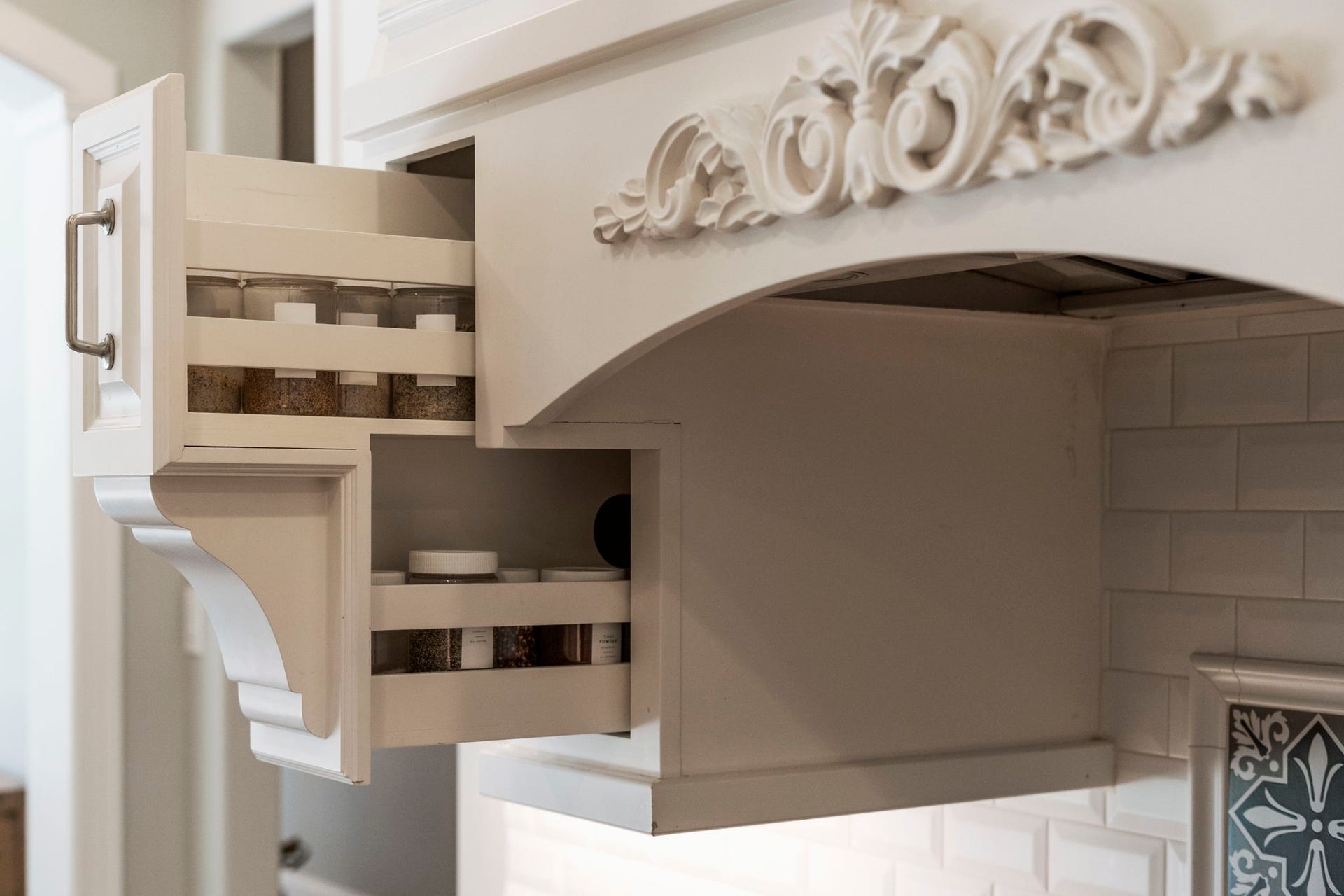 706 Oyster Creek Drive, Sugar Land, TX 77478 Custom cabinetry features convenient spice pull-outs, soft-close cabinets and drawers, and under-cabinet lighting.
